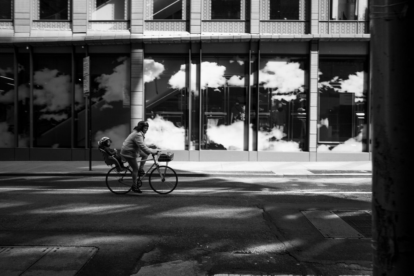A person riding a bike down a city street.