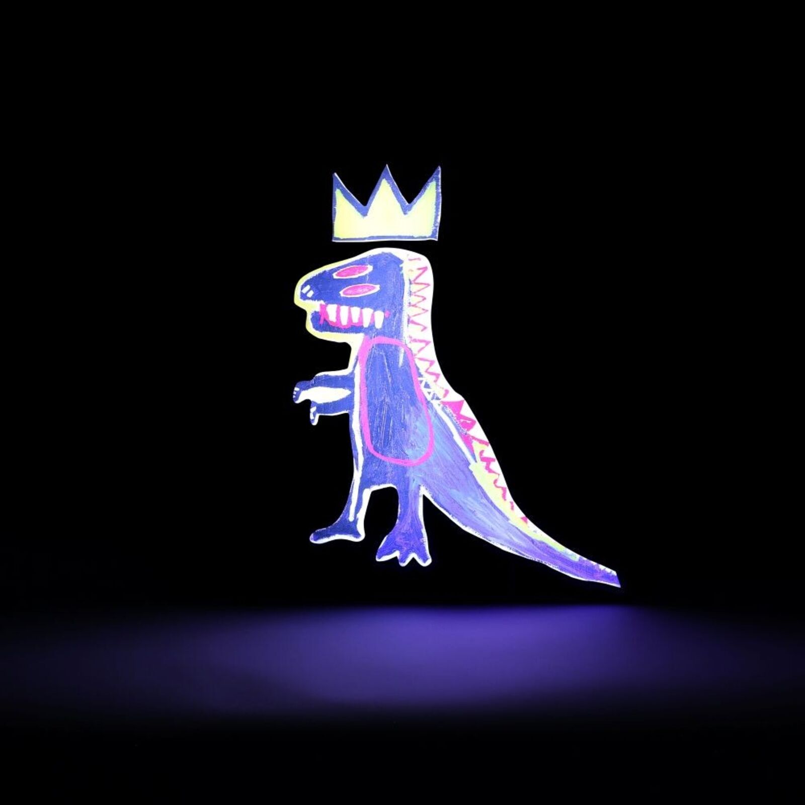 A wooden dinosaur with a crown on its head.