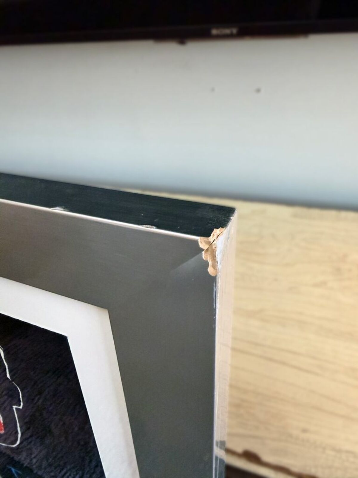 A blackboard with a drawing of a man holding a hammer.