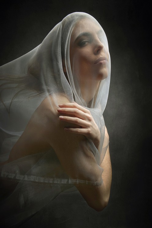 A woman with a veil covering her face. 