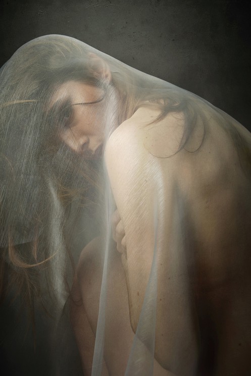 A woman with a veil covering her face. 