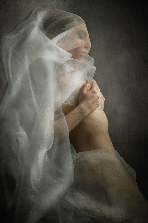 A woman with a veil covering her face. 