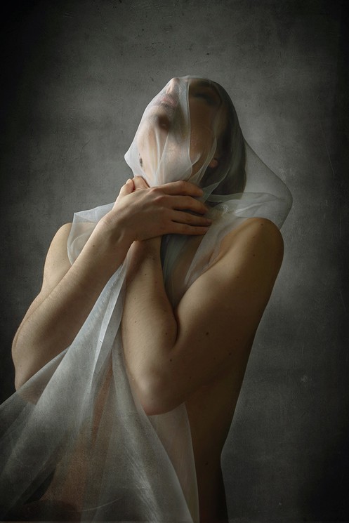 A woman with a veil covering her face. 