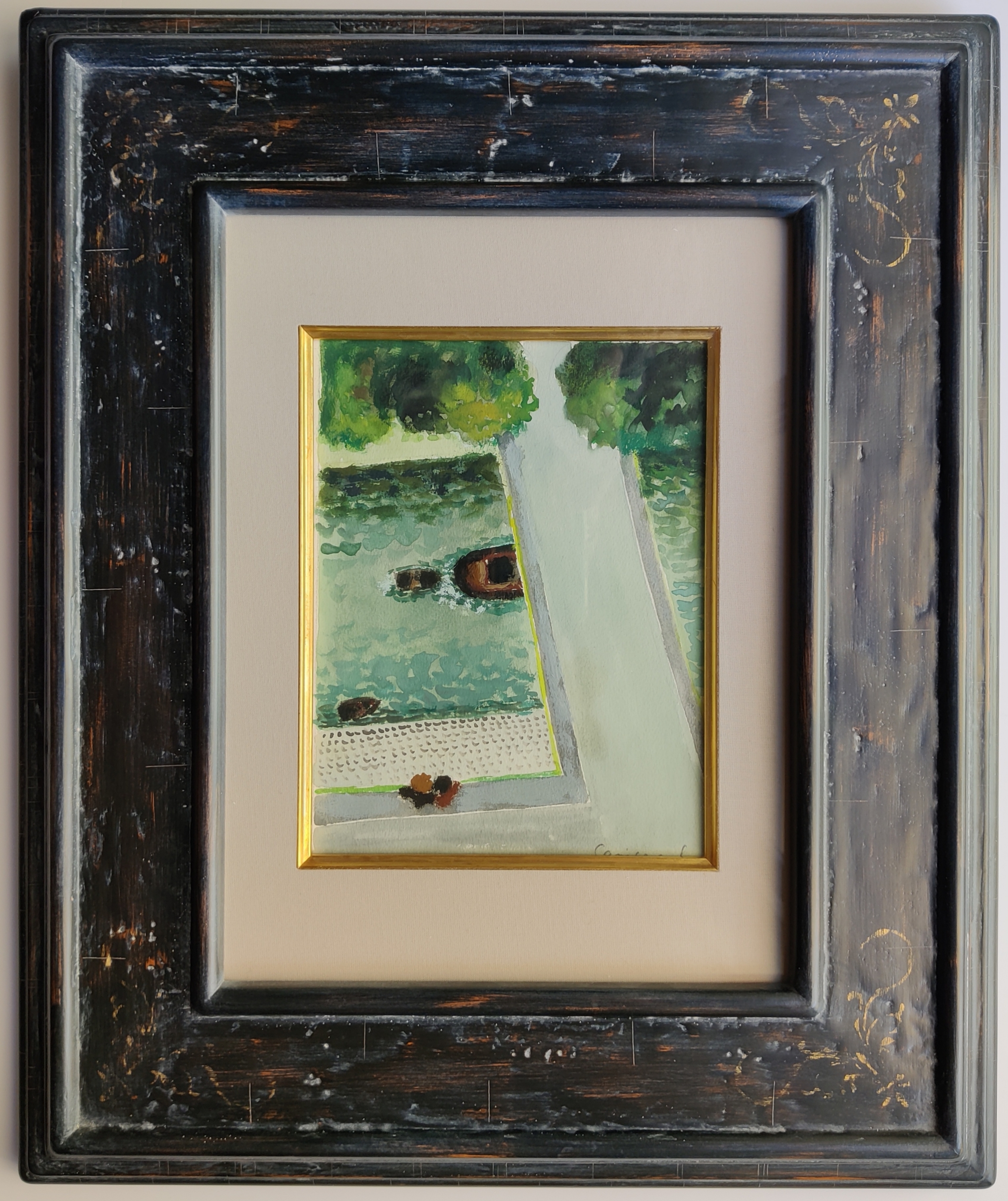 A painting hanging on a wall in a black frame.