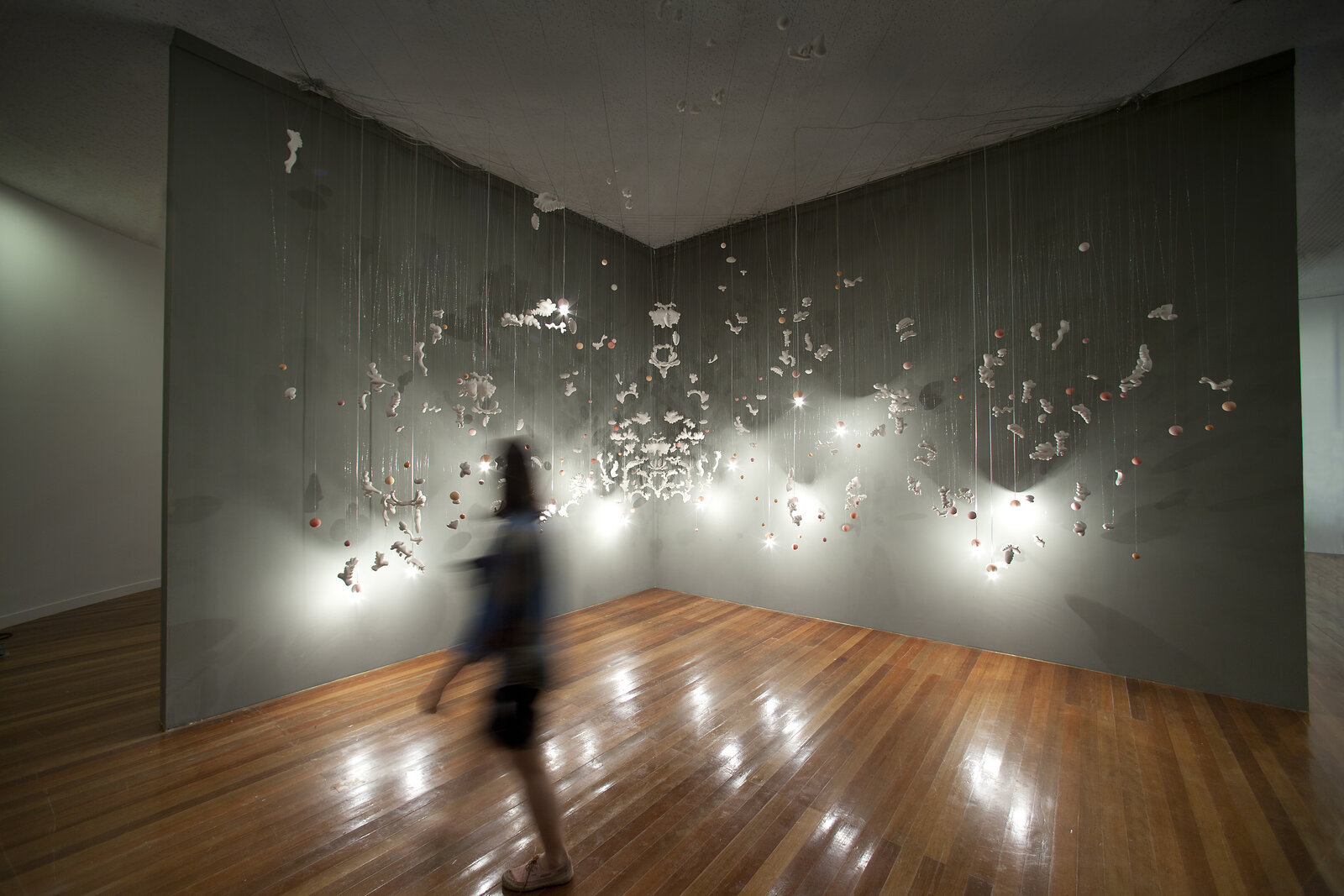 Artwork by Jeanne Quinn, Floating, Made of Porcelain, wire, paint, electrical hardware 