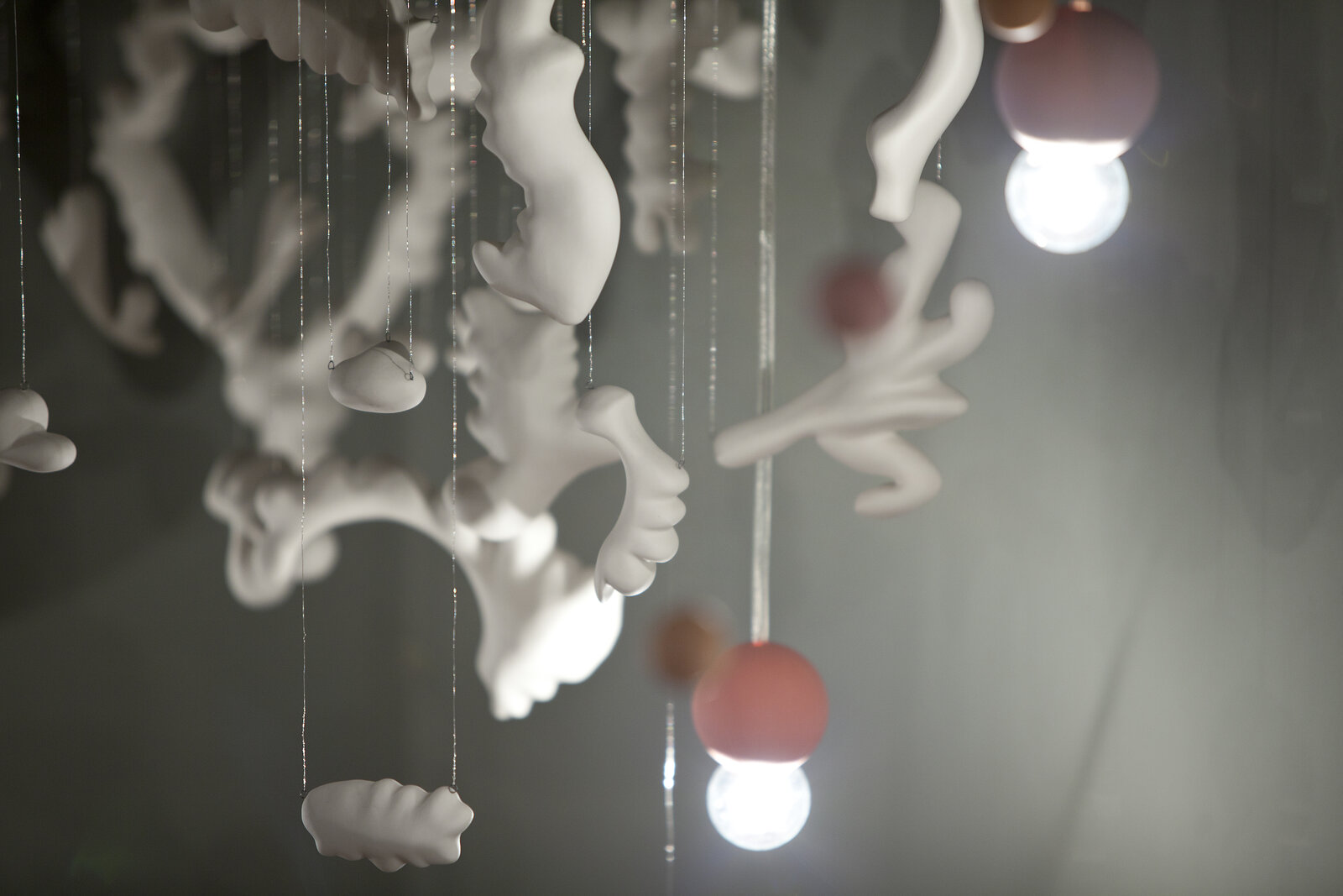 Artwork by Jeanne Quinn, Floating, Made of Porcelain, wire, paint, electrical hardware 