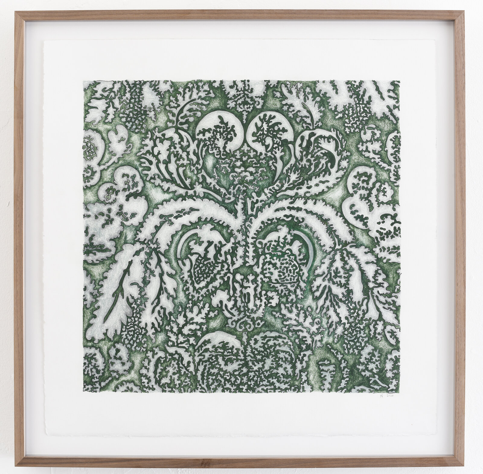A symmetrical abstract pattern featuring organic, coral-like shapes in deep green and white.
