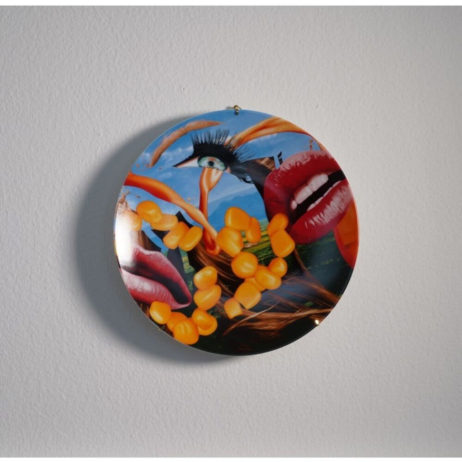 A plate with a picture of a woman's face on it.