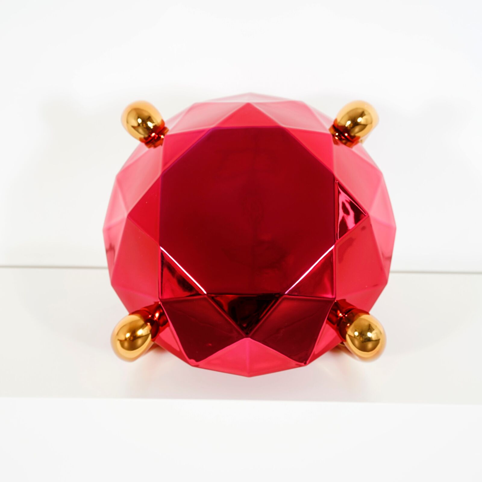 A pair of red, blue and gold vases sitting next to each other.