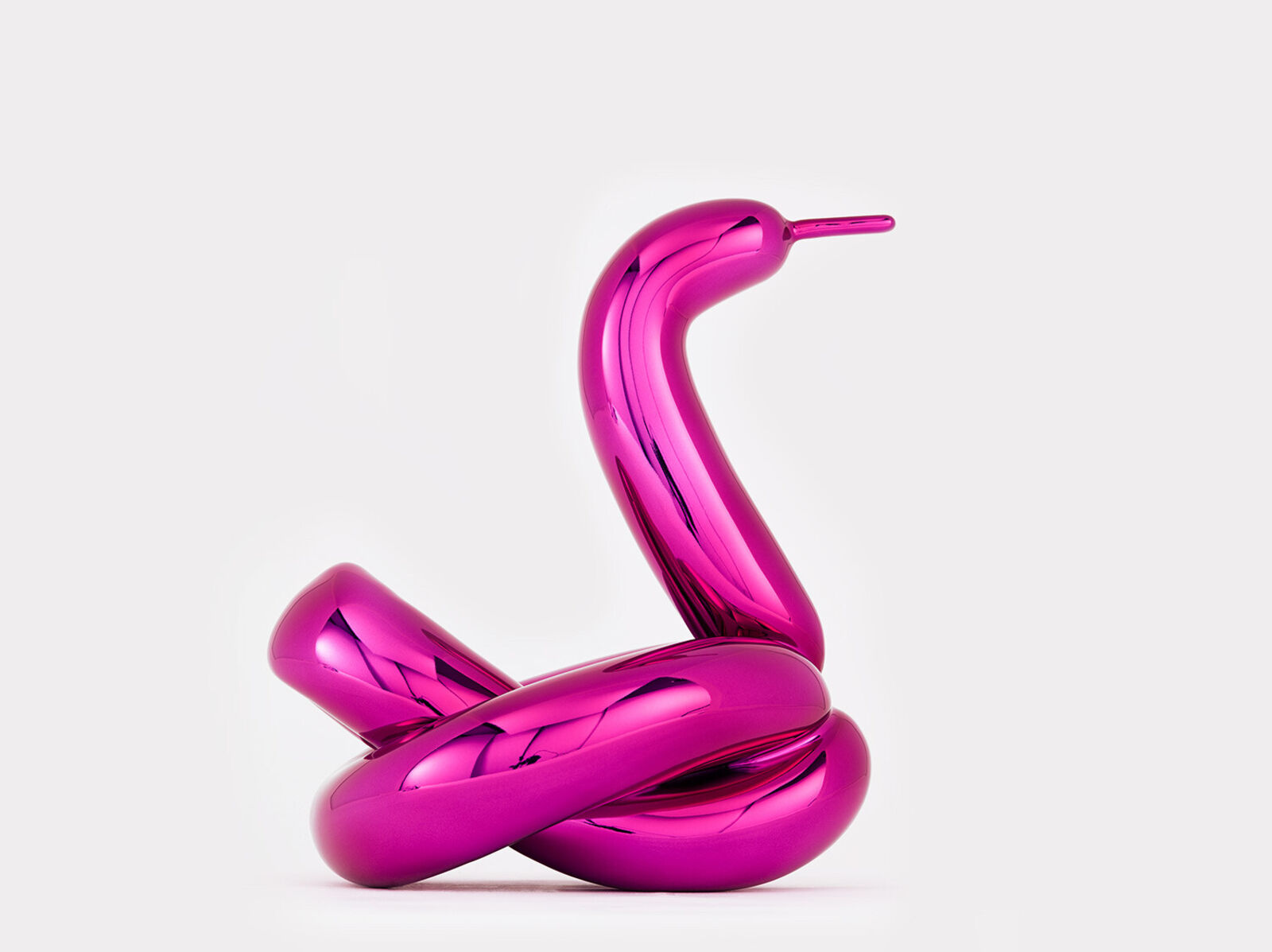 A pink sculpture of a snake on a white background.