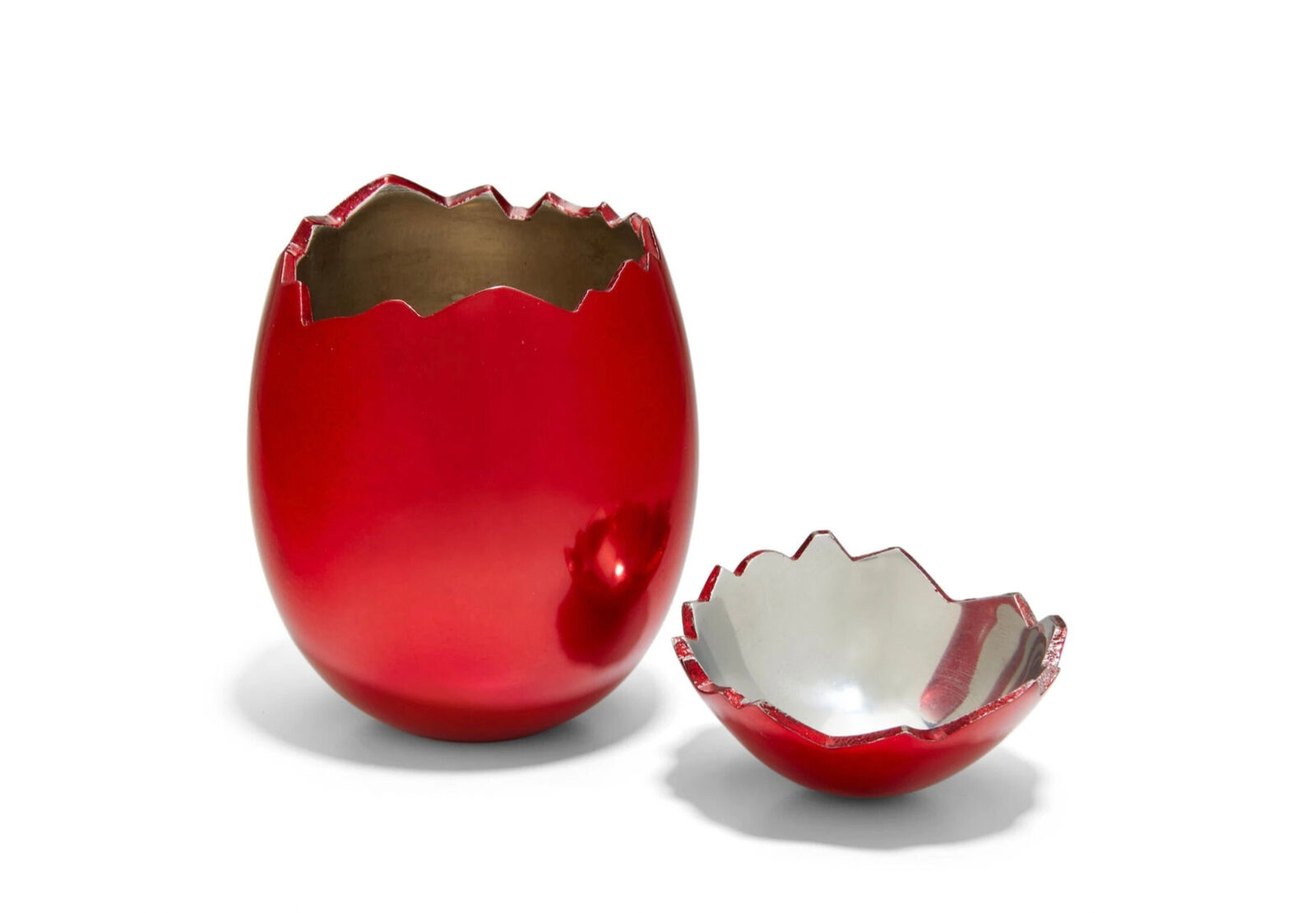 A red vase and a white bowl sitting next to each other.