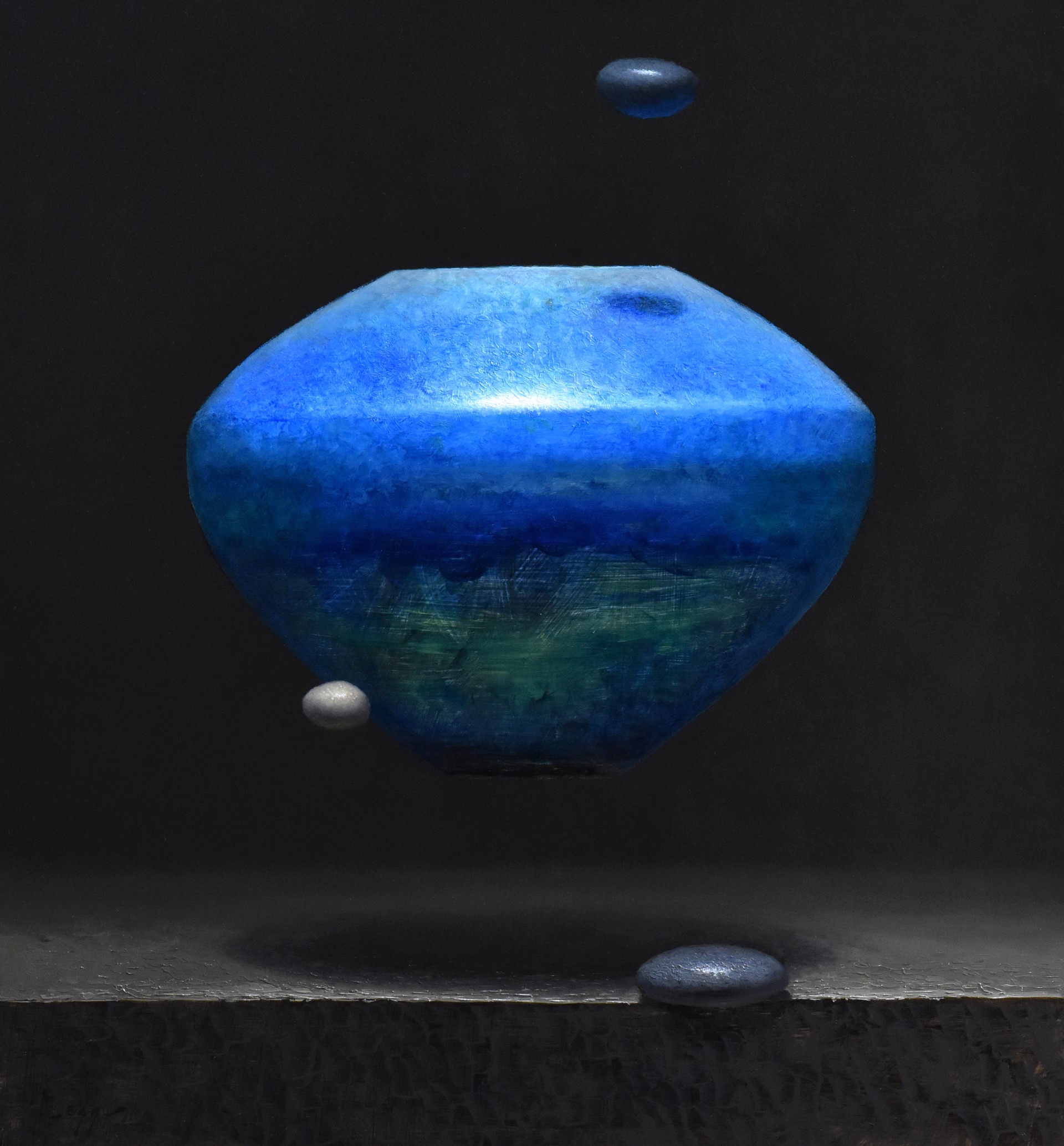 A blue vase sitting on top of a black surface.