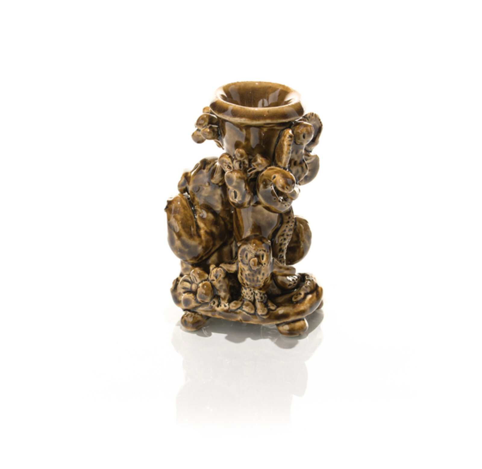 A glossy brown ceramic candlestick featuring a textured, organic design with animal-like figures and floral elements.