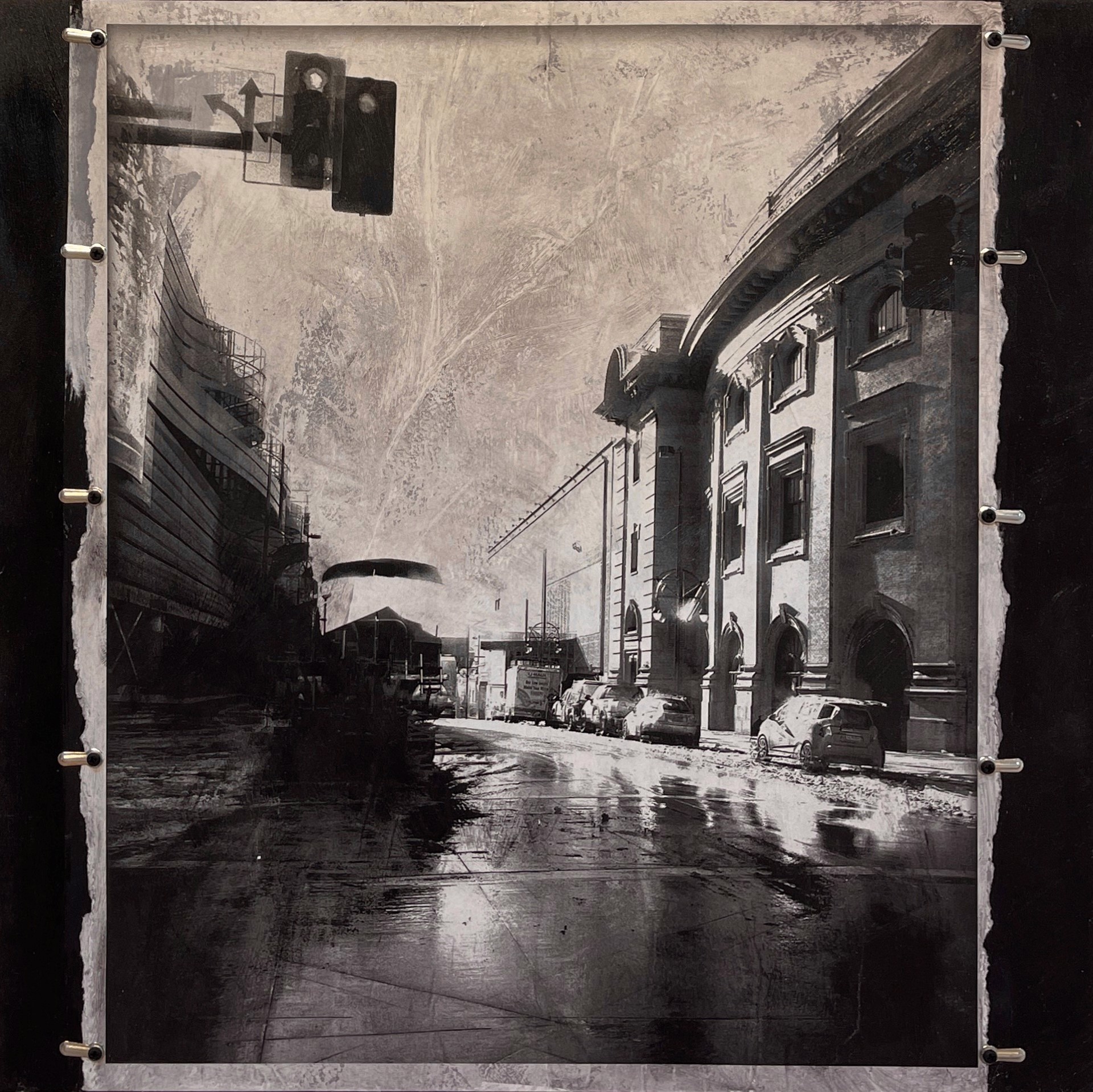 A black and white photo of a city street.