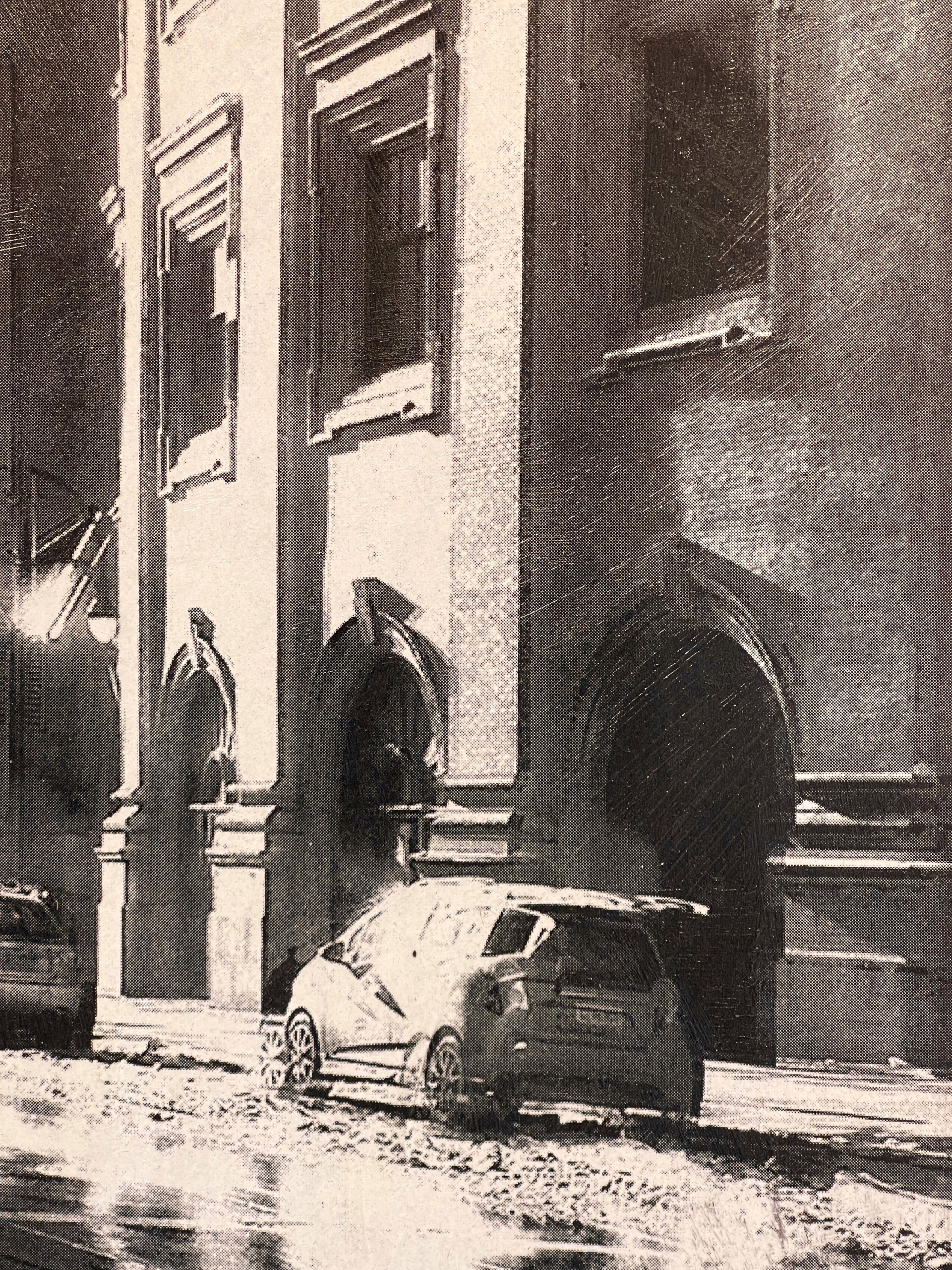 A black and white photo of a city street.