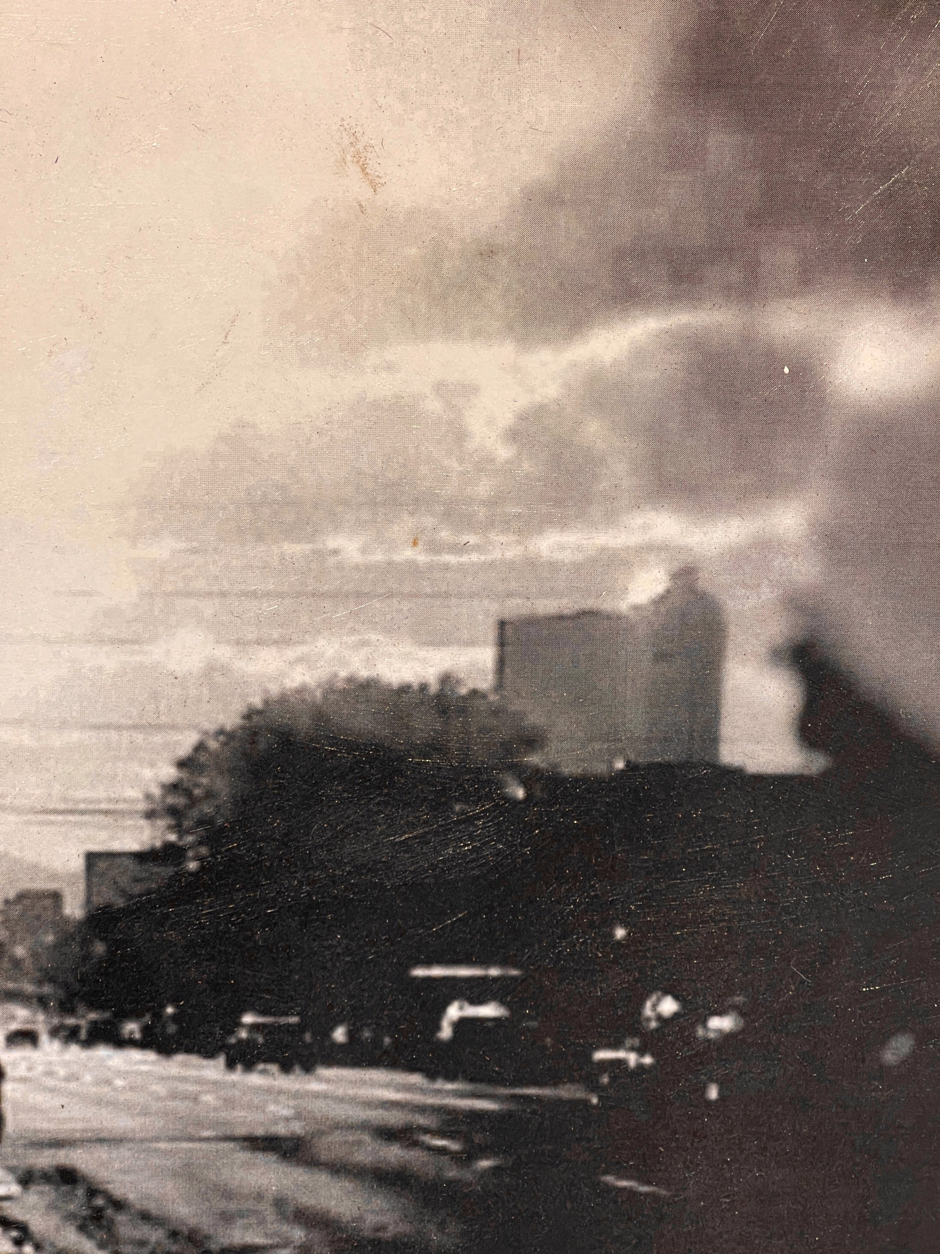 A black and white photo of a person walking down a street.