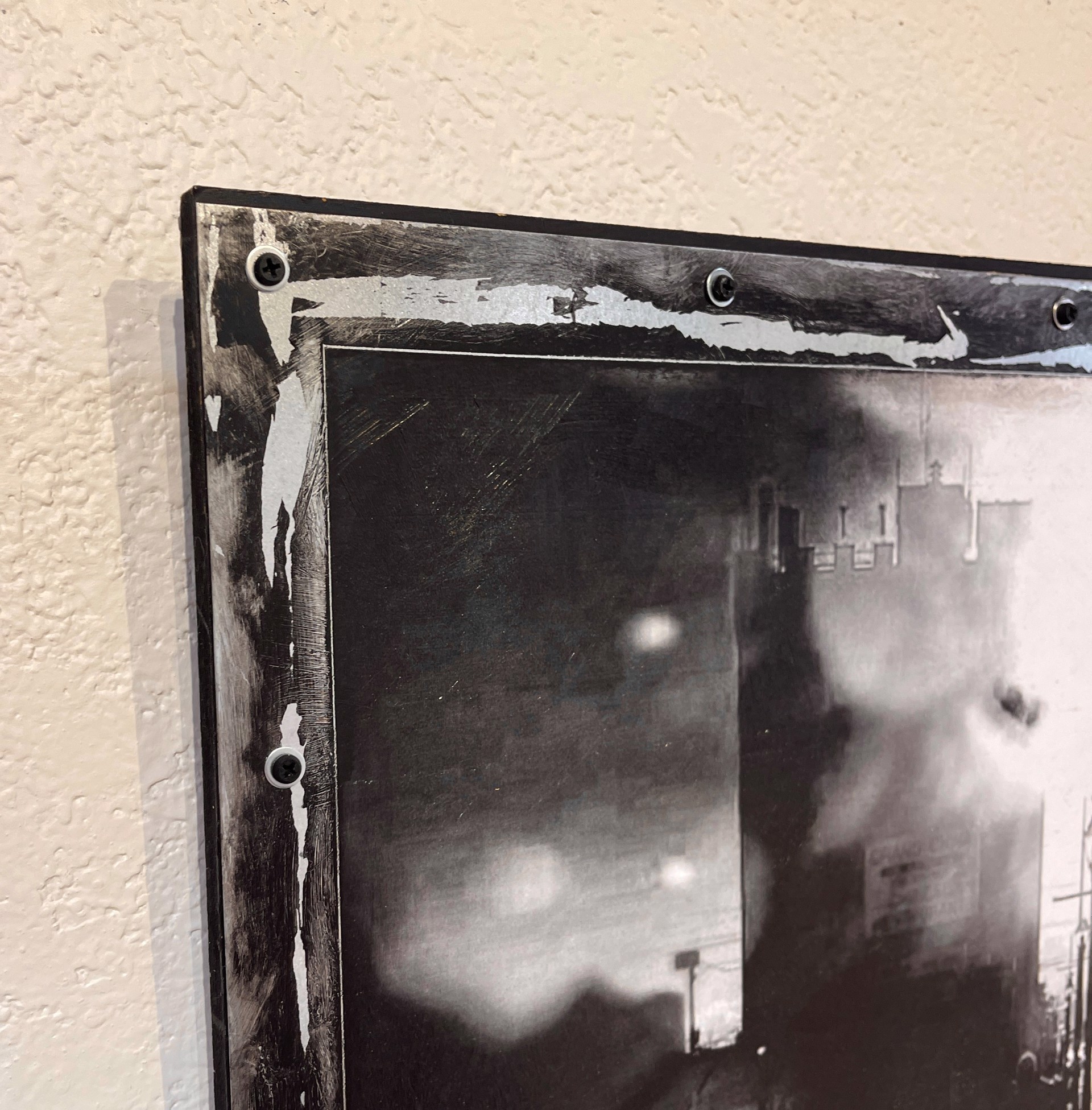 A black and white photo of a person walking down a street.