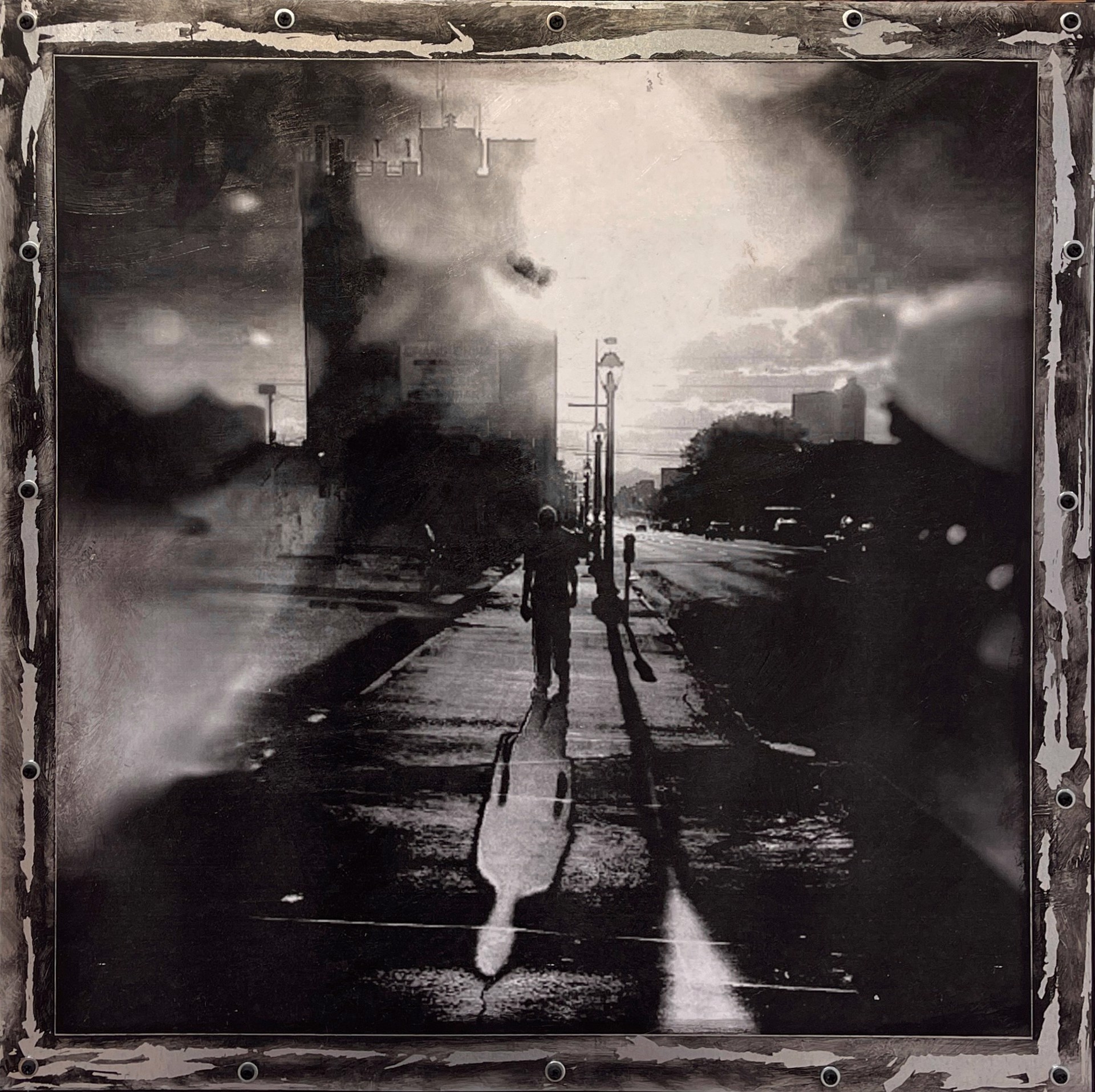 A black and white photo of a person walking down a street.