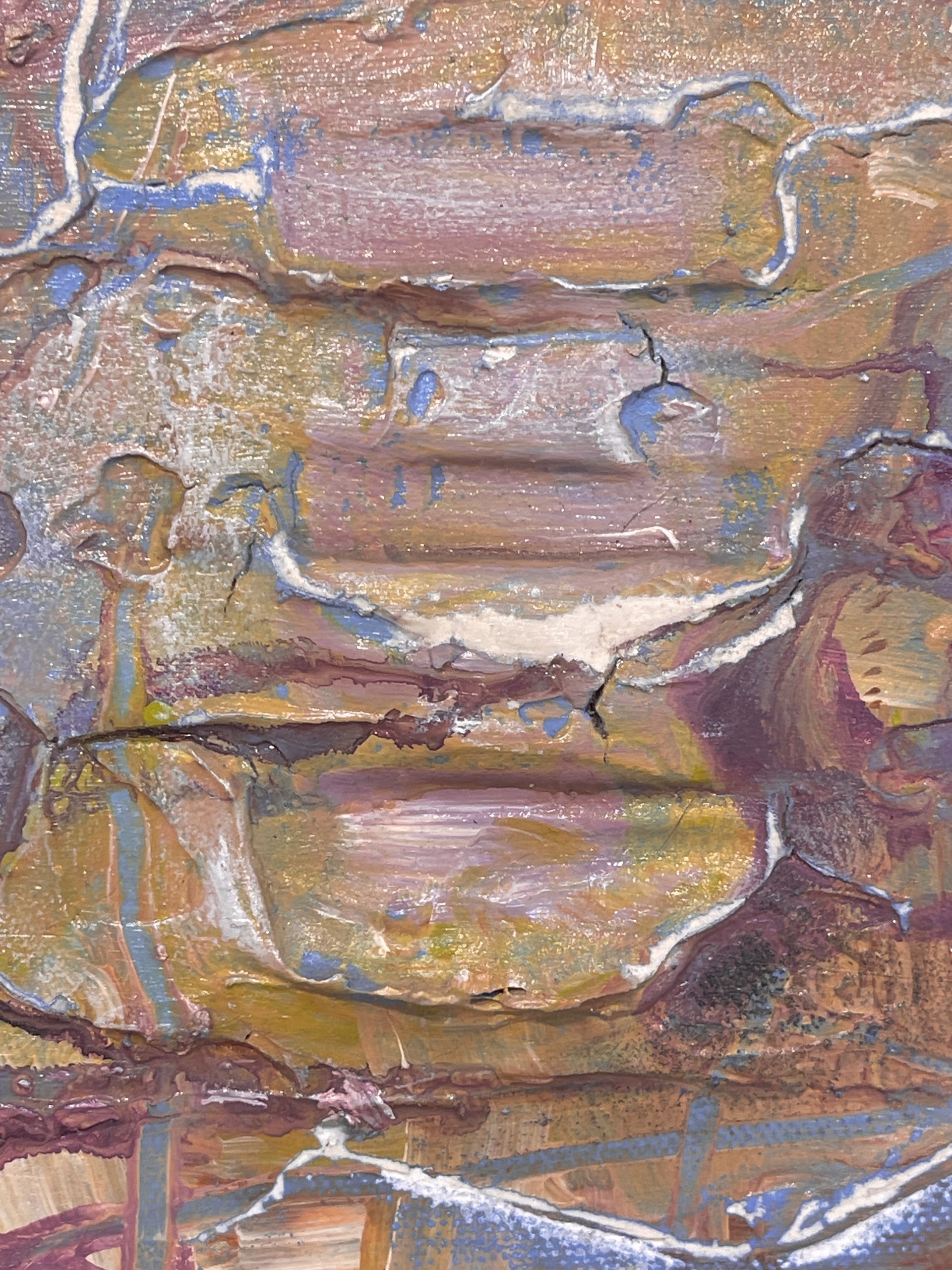 A painting of a face on a piece of paper.