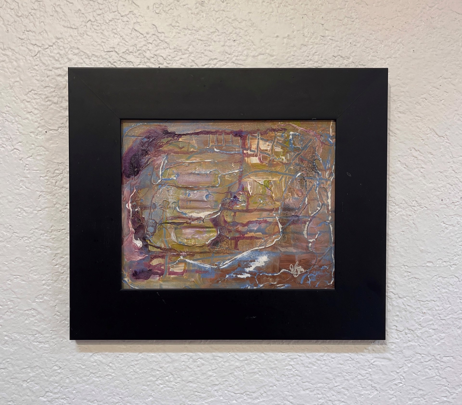 A painting of a face on a piece of paper.