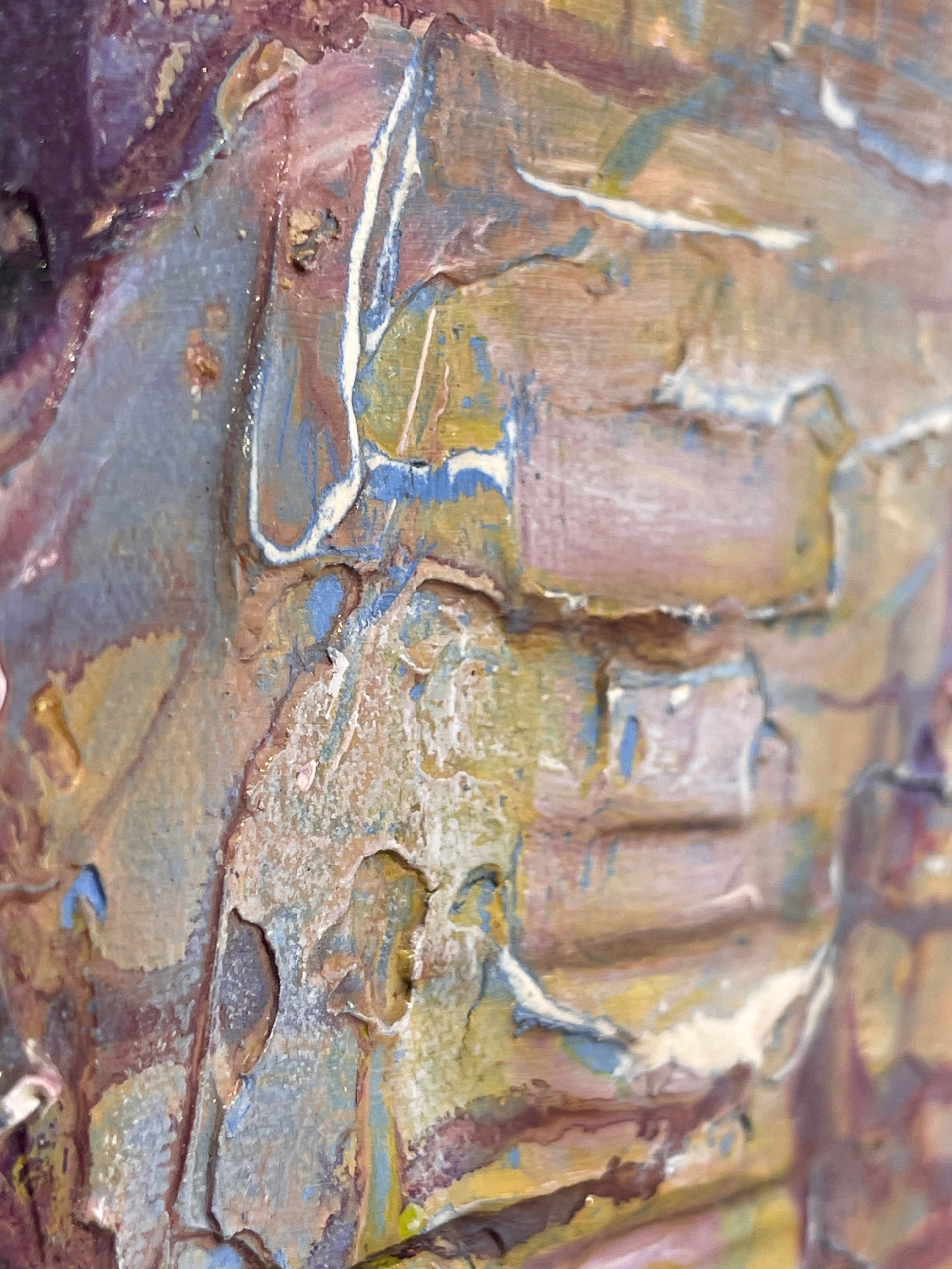 A painting of a face on a piece of paper.