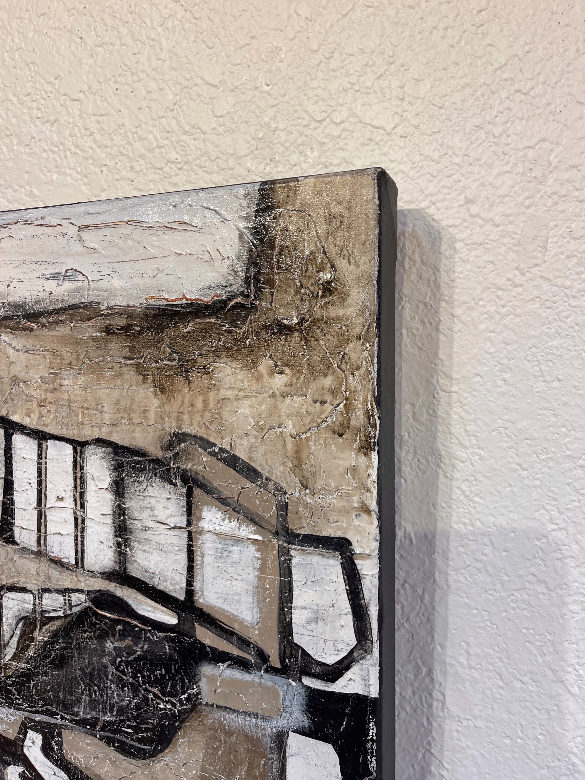 A painting of a black and white abstract painting on a wall.