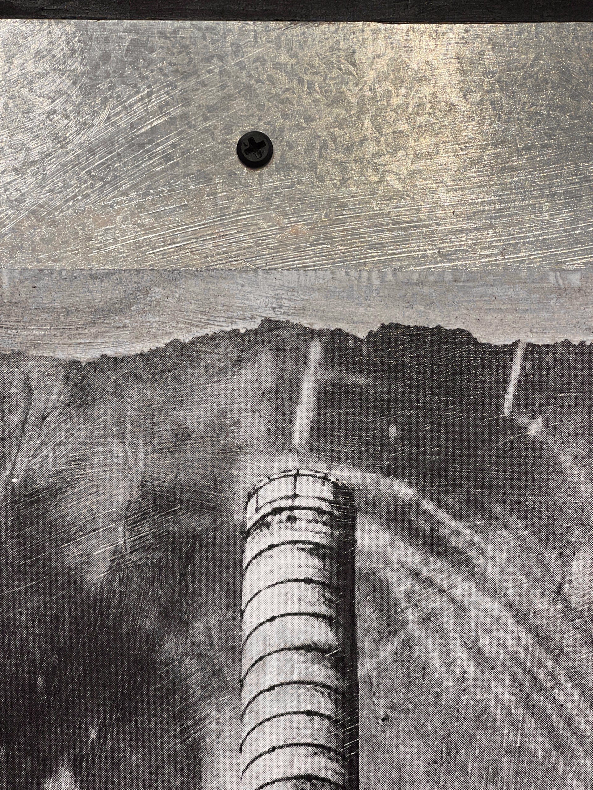 A black and white photo of a factory with smoke coming out of it.