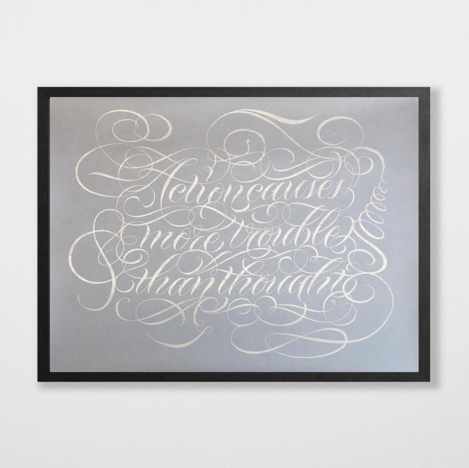 A silver metallic print of ornate calligraphy on a matte grey background.