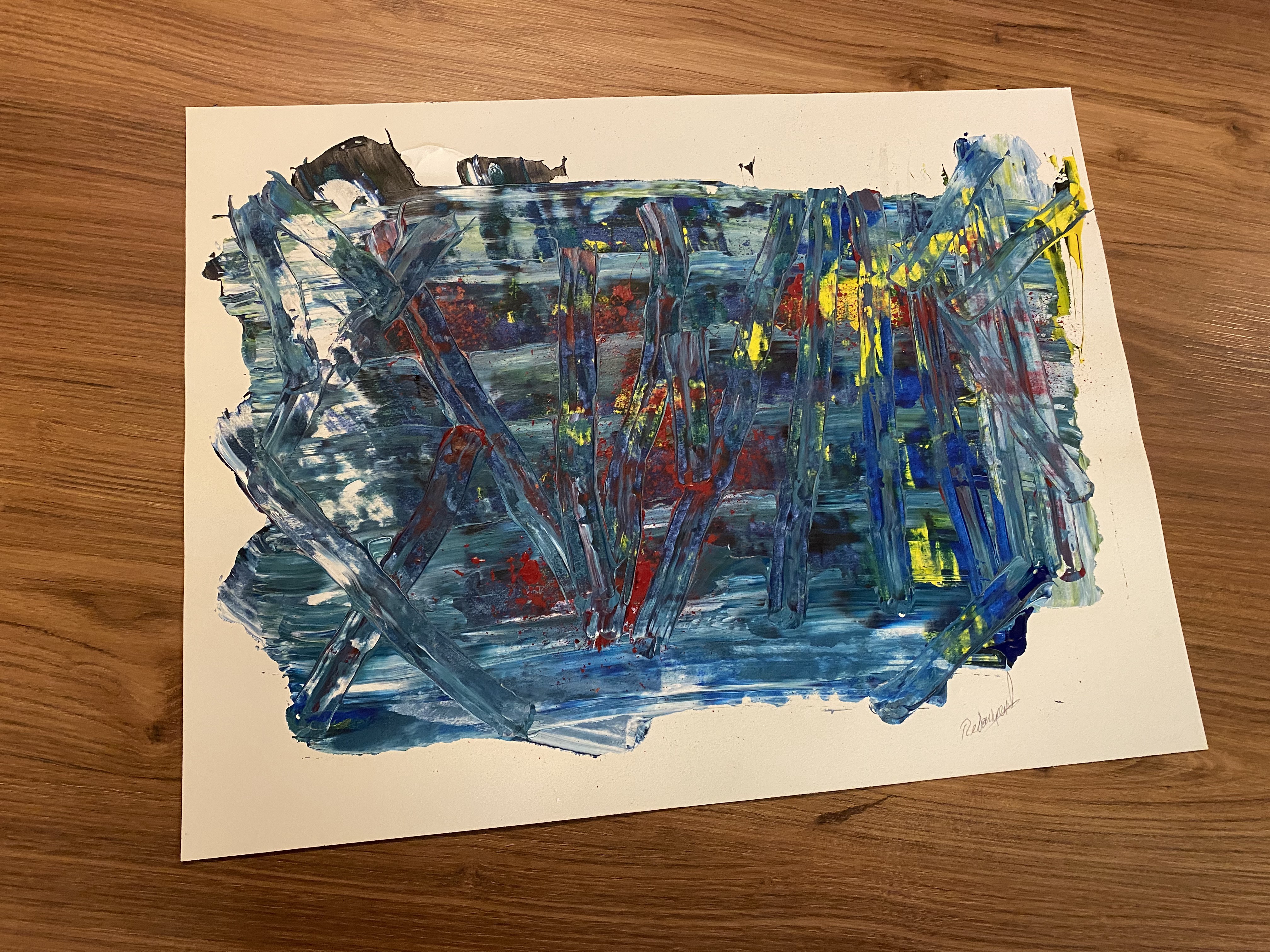 A painting on a piece of paper on a table.