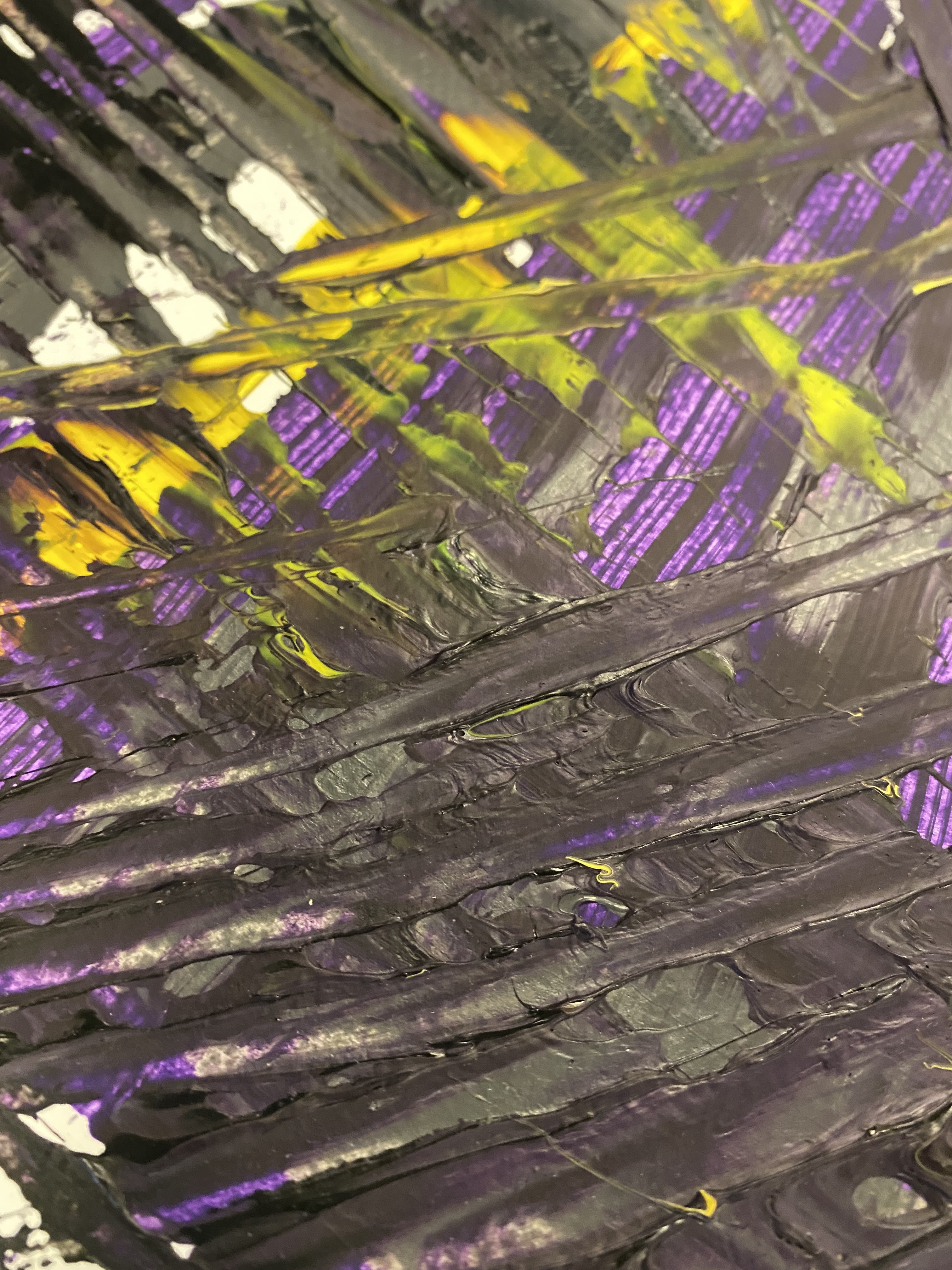 A painting on a wooden table with purple and yellow paint.