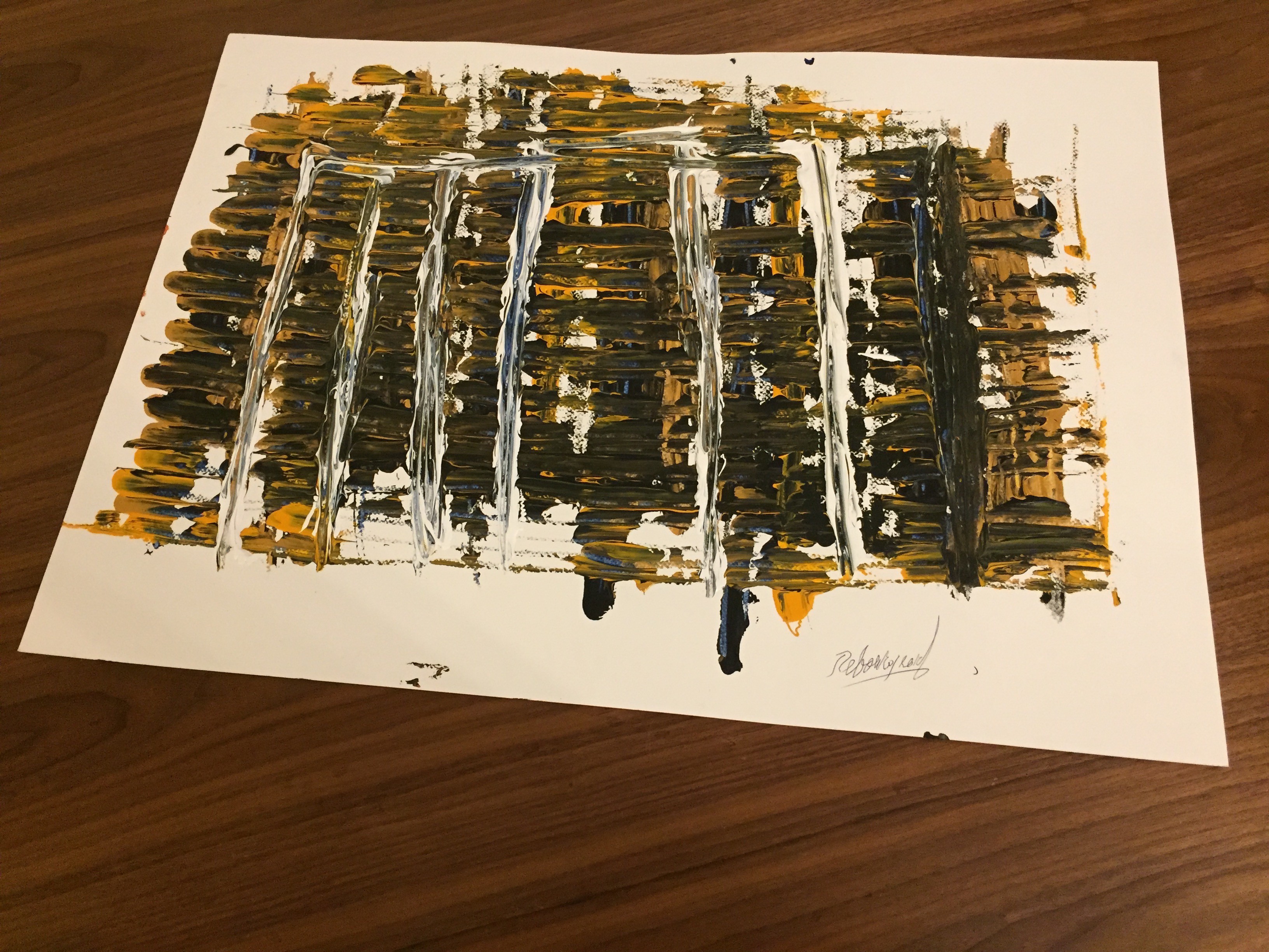 A painting on a piece of paper on a table.