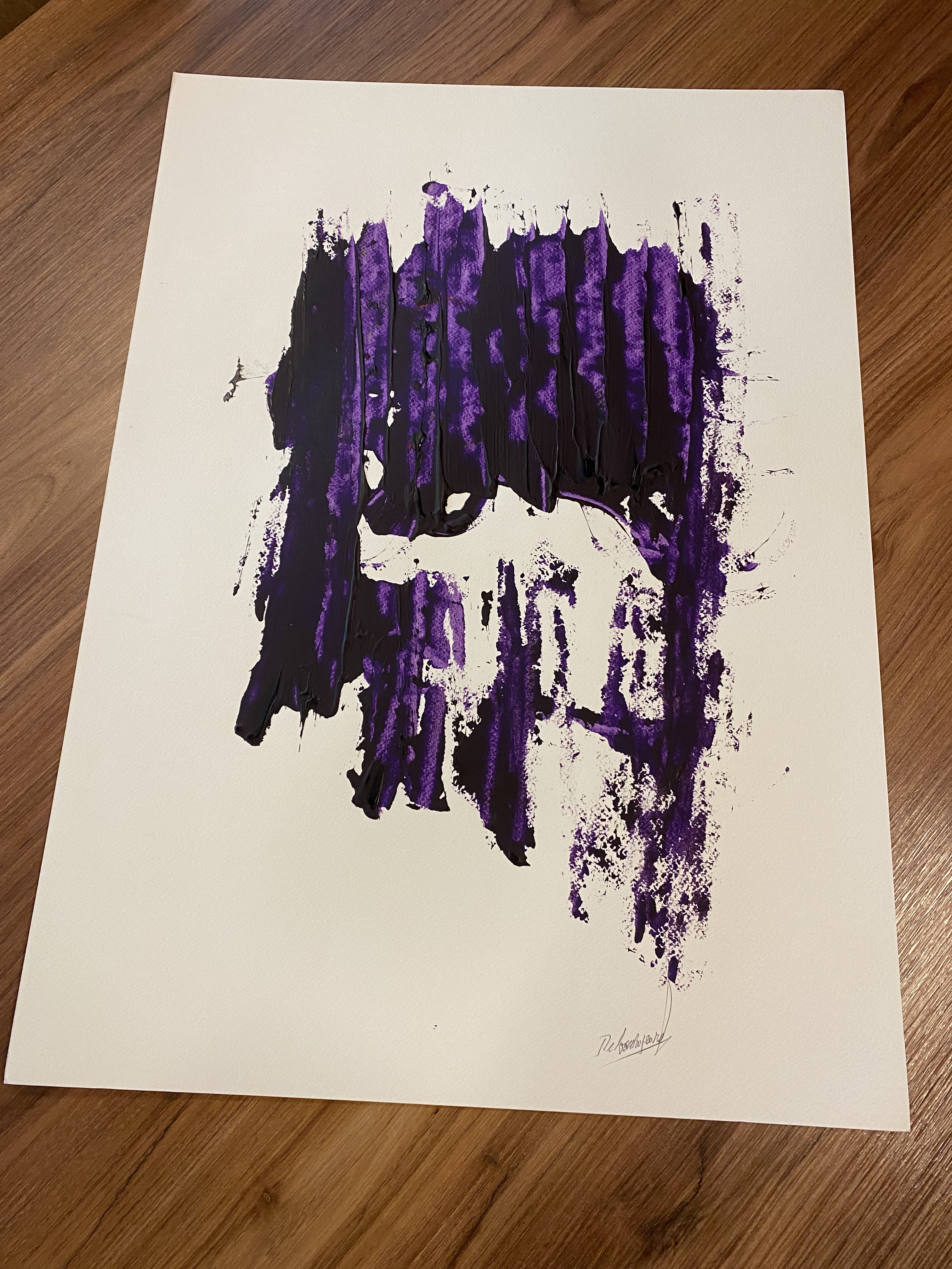 A piece of paper with a purple paint splatter on it.