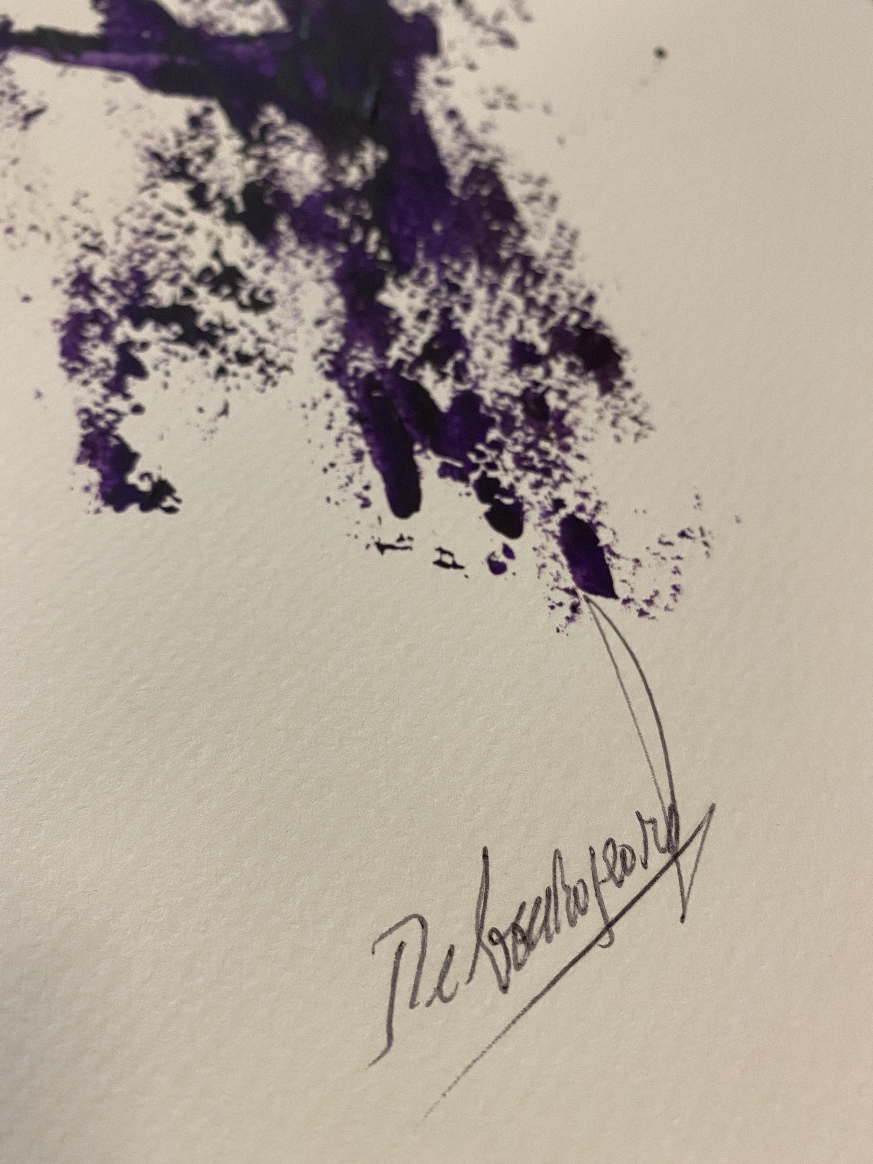 A piece of paper with a purple paint splatter on it.