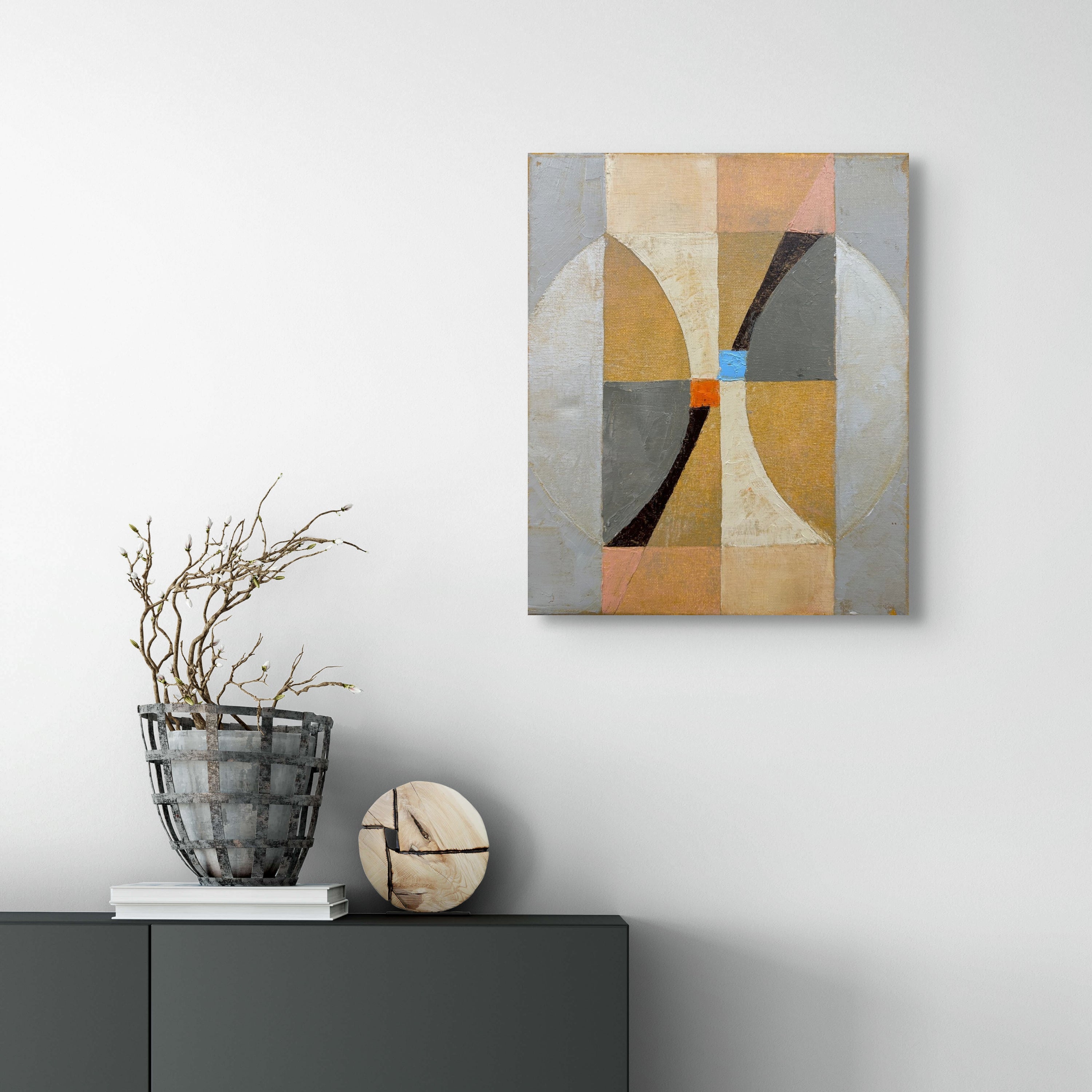 A painting on a white wall with a blue and orange design.