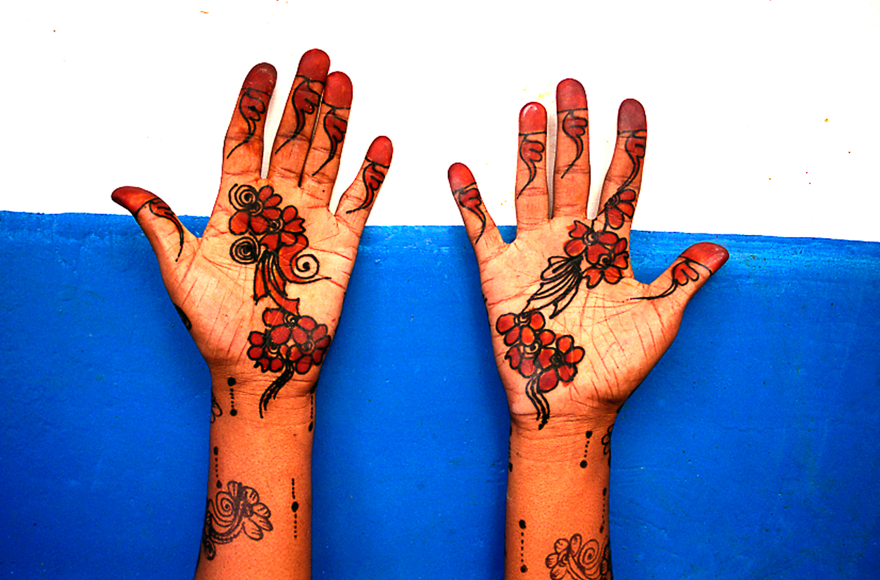A pair of hands with henna tattoos on them. 