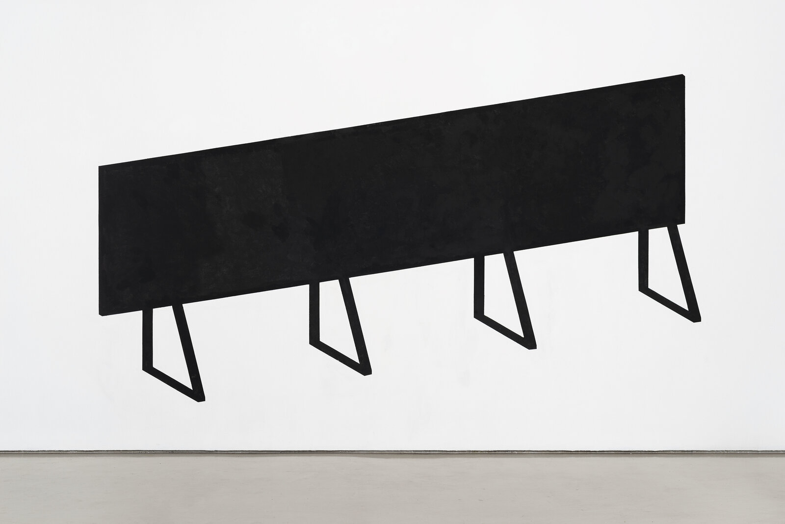 A black and white painting on a white wall.