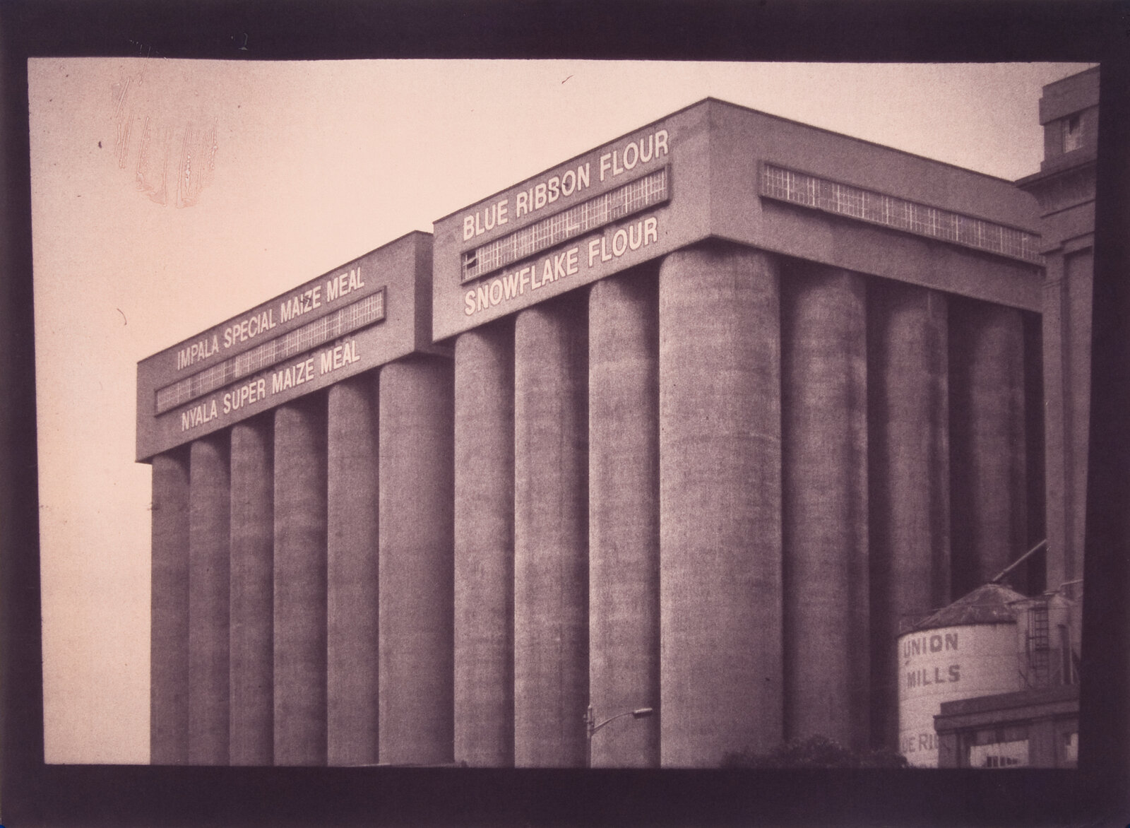 A black and white photo of a grain elevator.