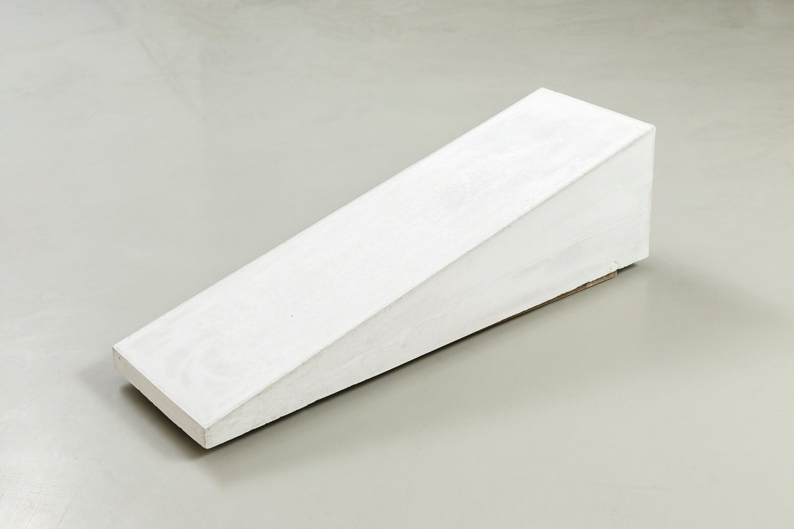 A piece of white concrete sitting on top of a table.