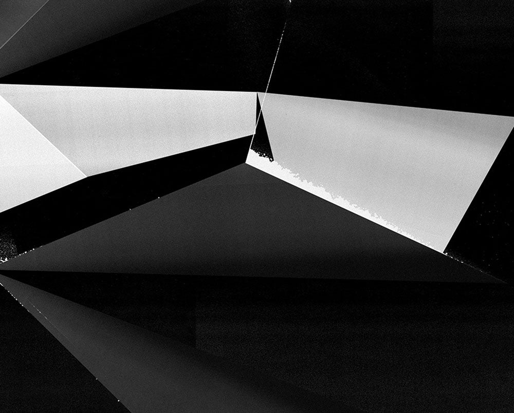 A black and white photo of a black and silver abstract painting.