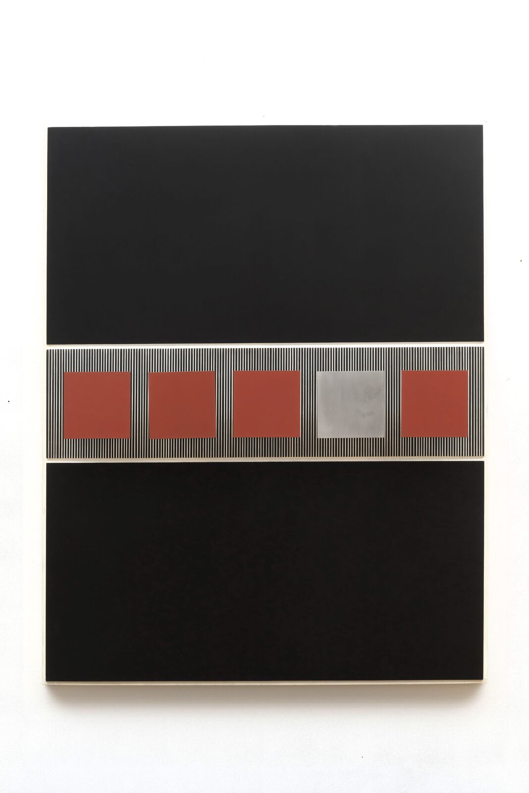 A black and red painting on a white wall.