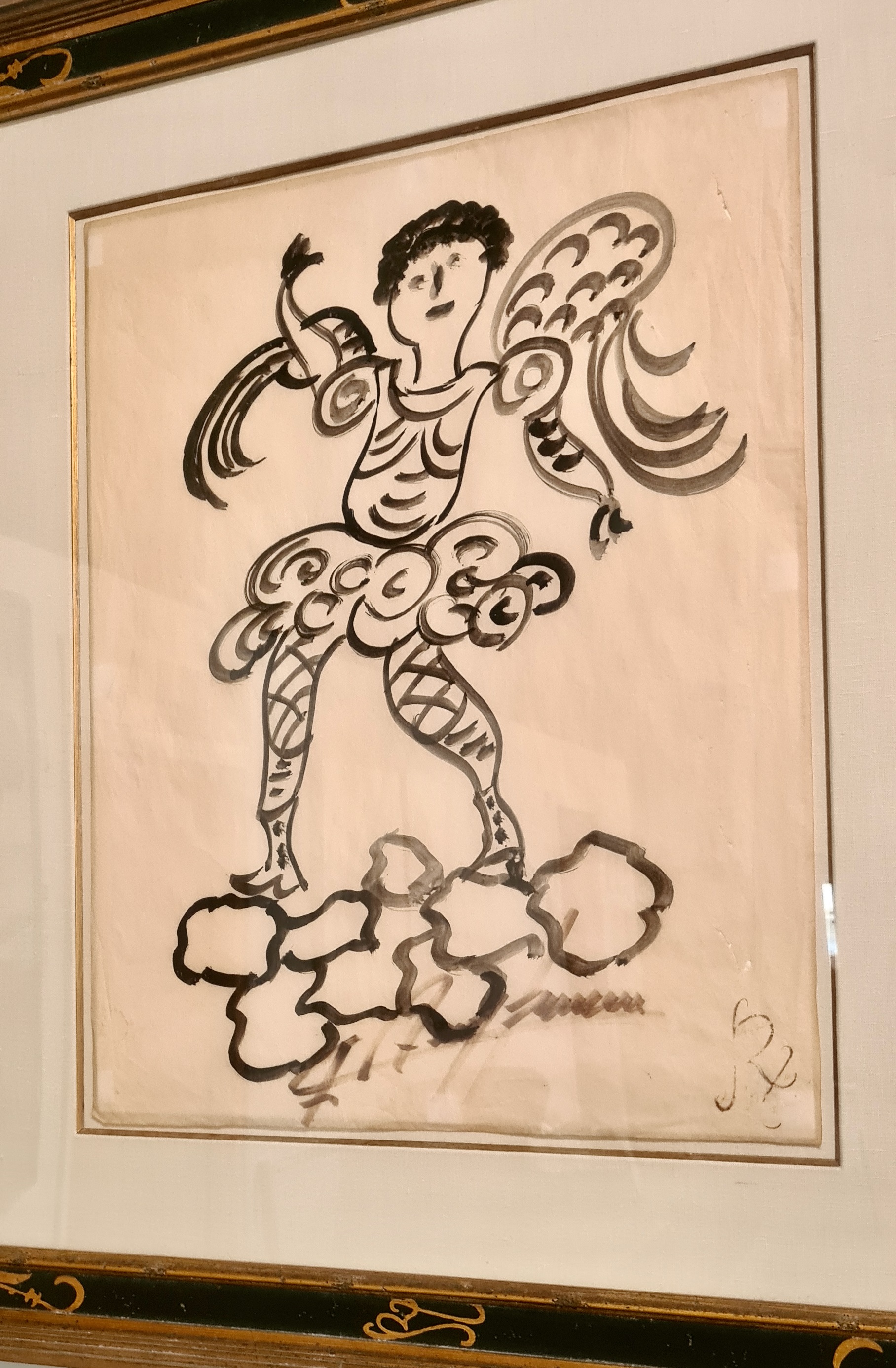 A framed drawing of an angel on a cloud.