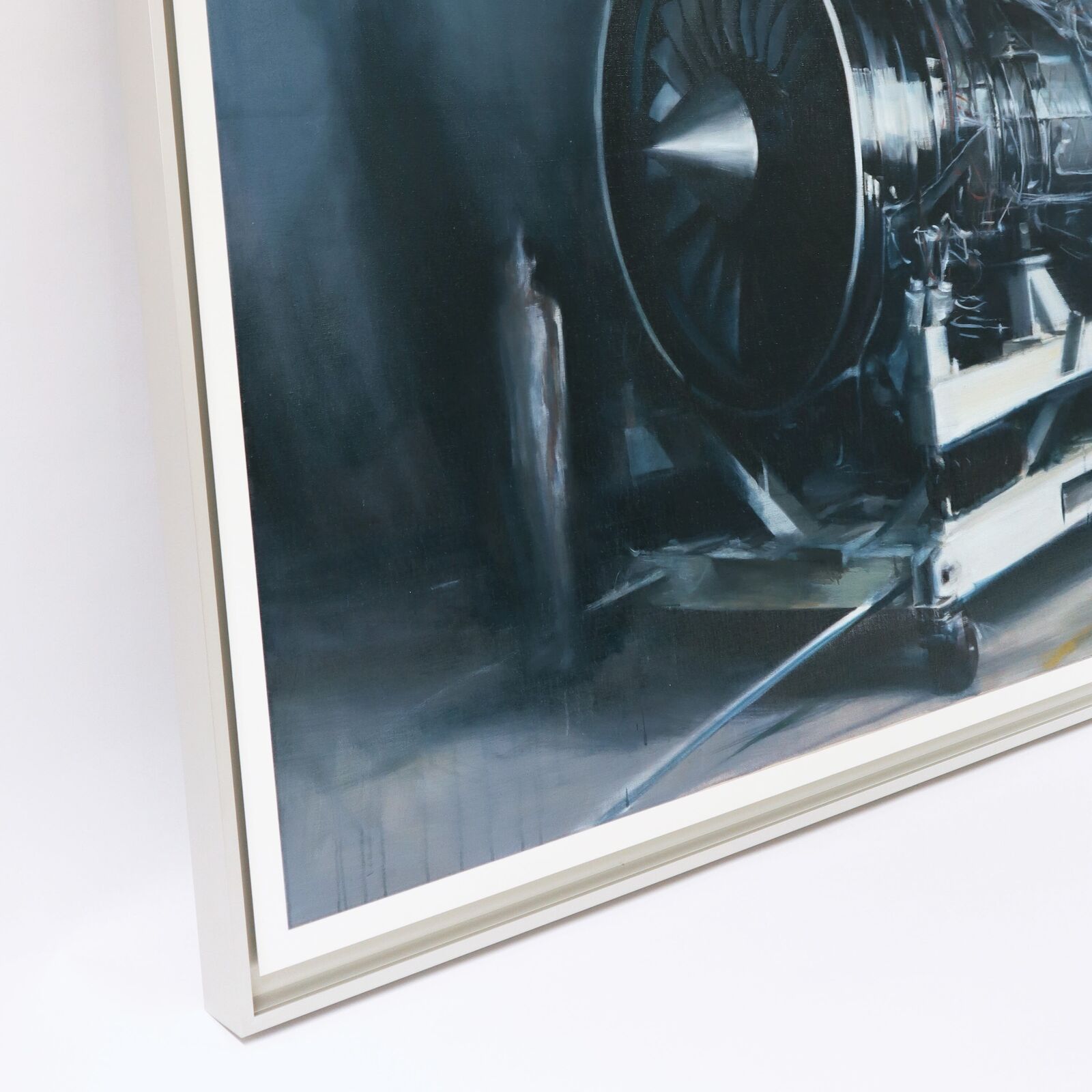 A painting of a jet engine on a cart in a hangar.