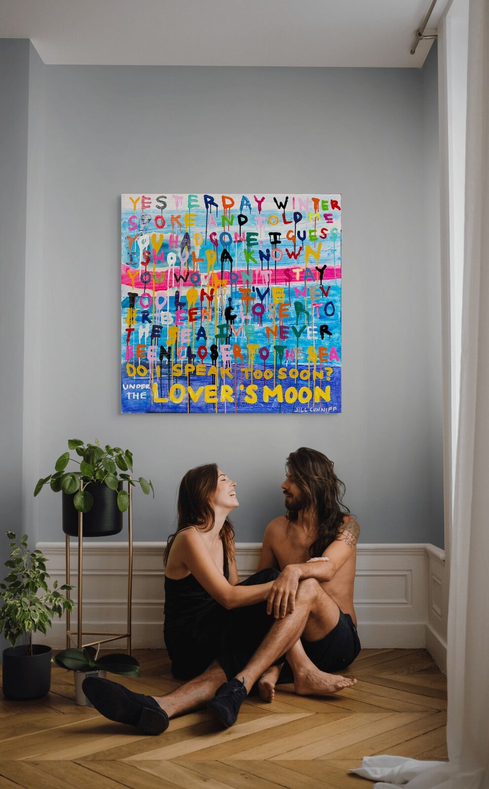 A painting with a quote on it that says, "Under the Lover's Moon."