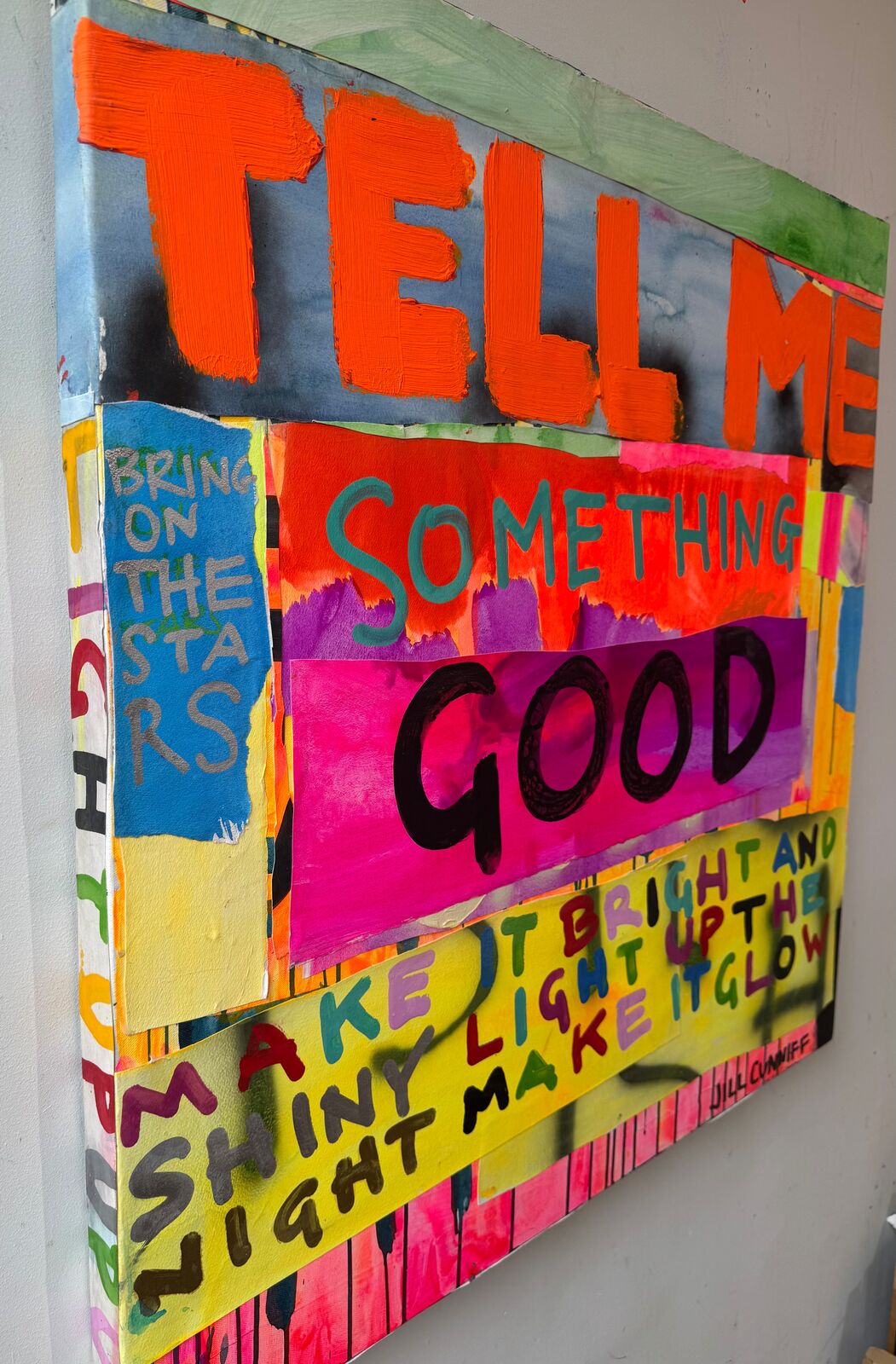A painting with the words tell me something good on it.