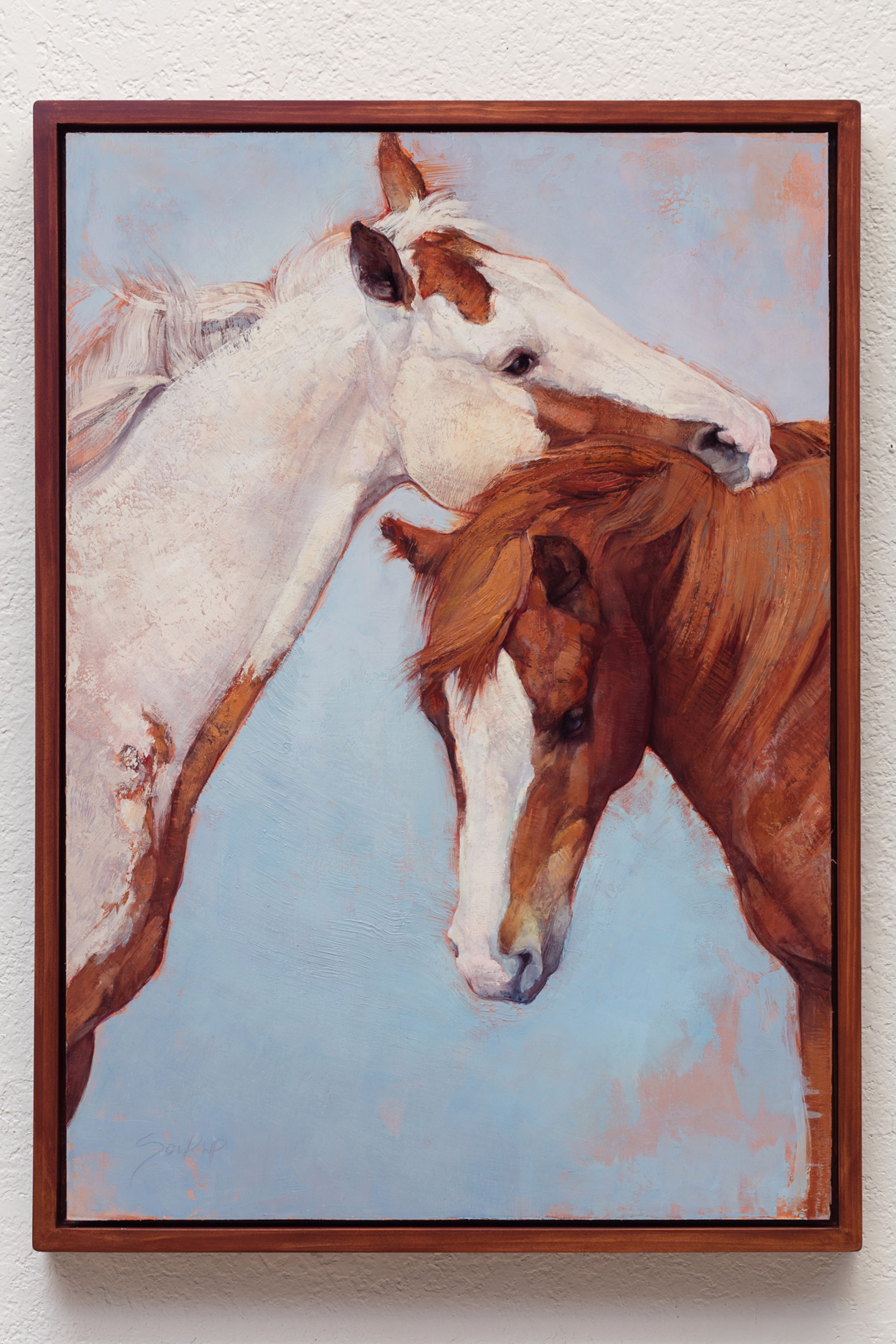 A tender oil painting of two horses sharing a gentle moment against a soft blue background.