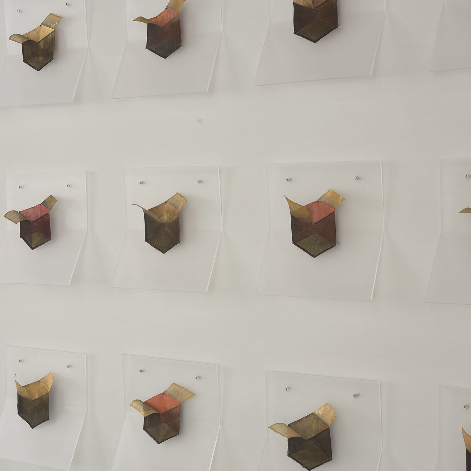 A grid of small, box-like objects arranged in three rows against a plain background.
