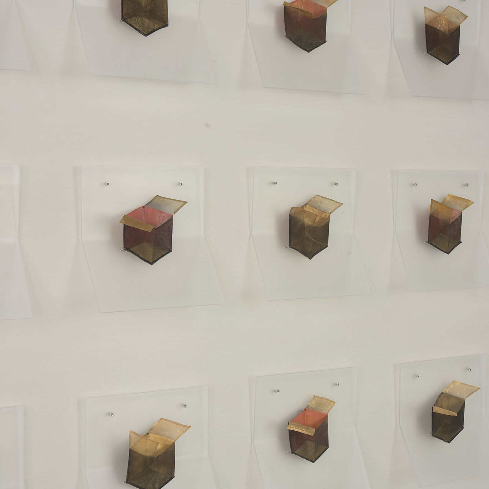 A grid of small, box-like objects arranged in three rows against a plain background.