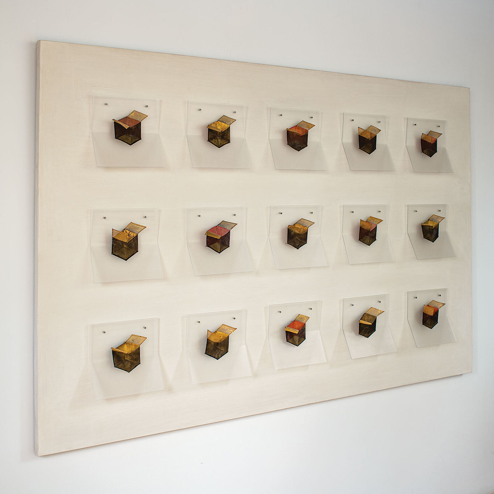 A grid of small, box-like objects arranged in three rows against a plain background.