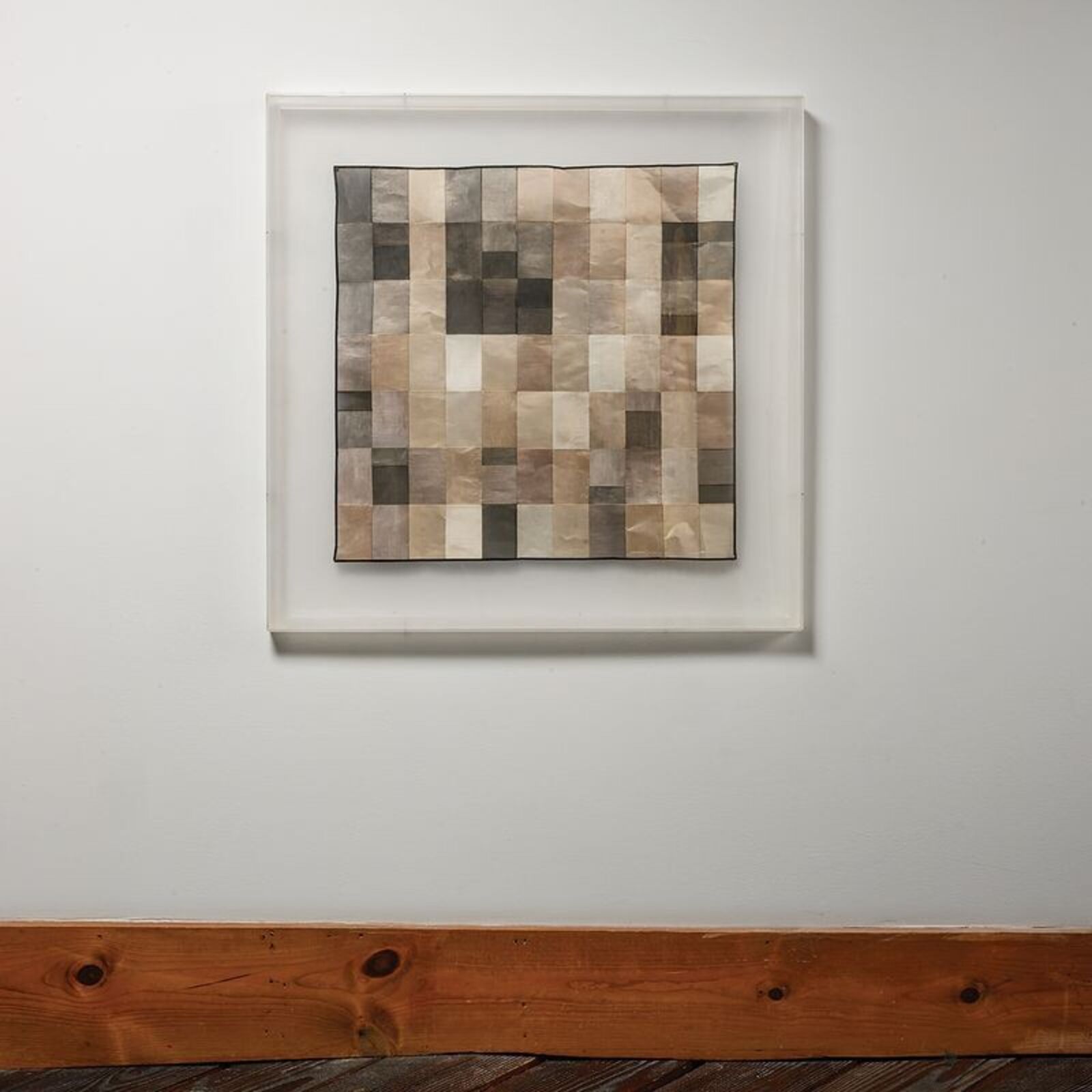 A picture of a piece of art hanging on a wall.