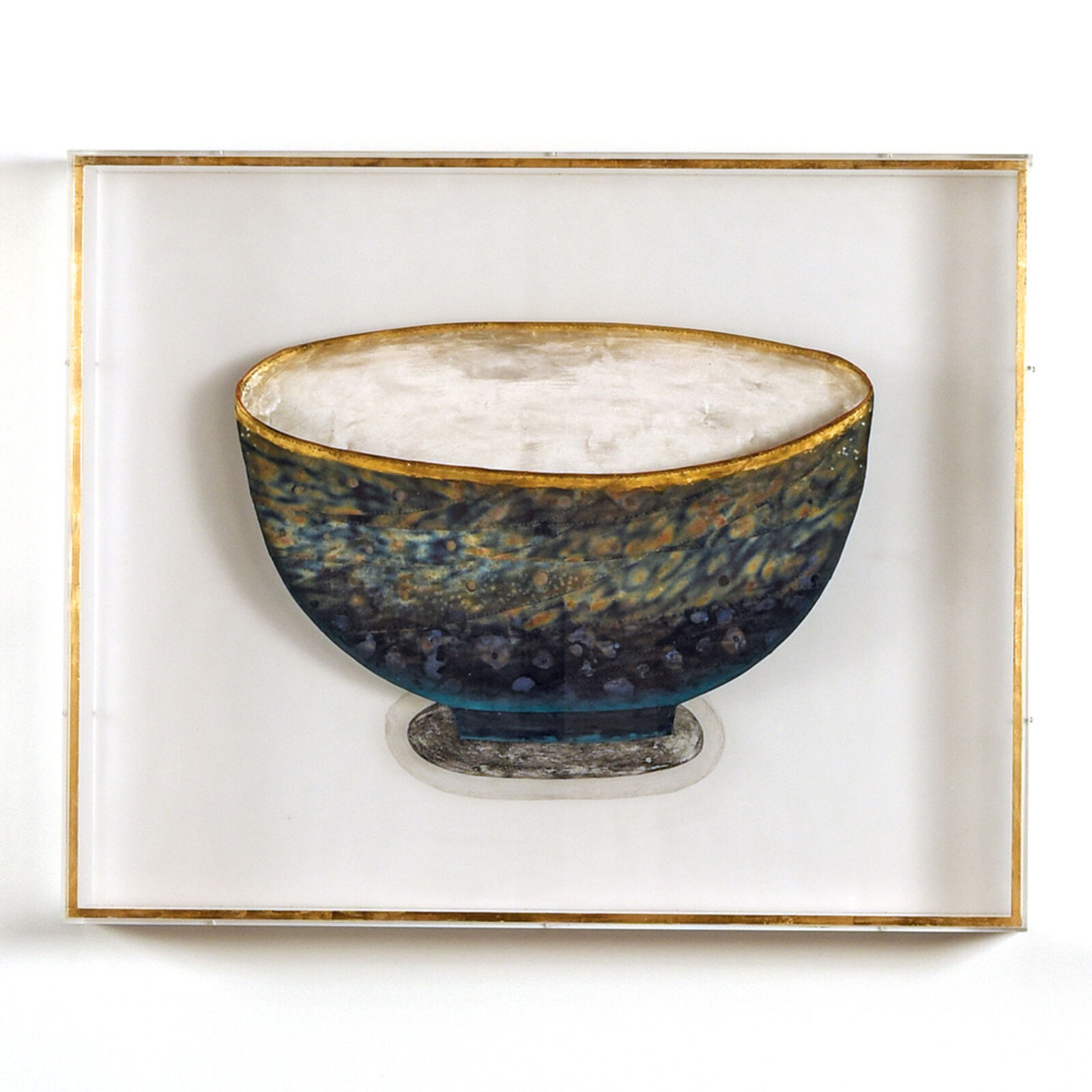 A picture of a blue and gold bowl in a white frame.